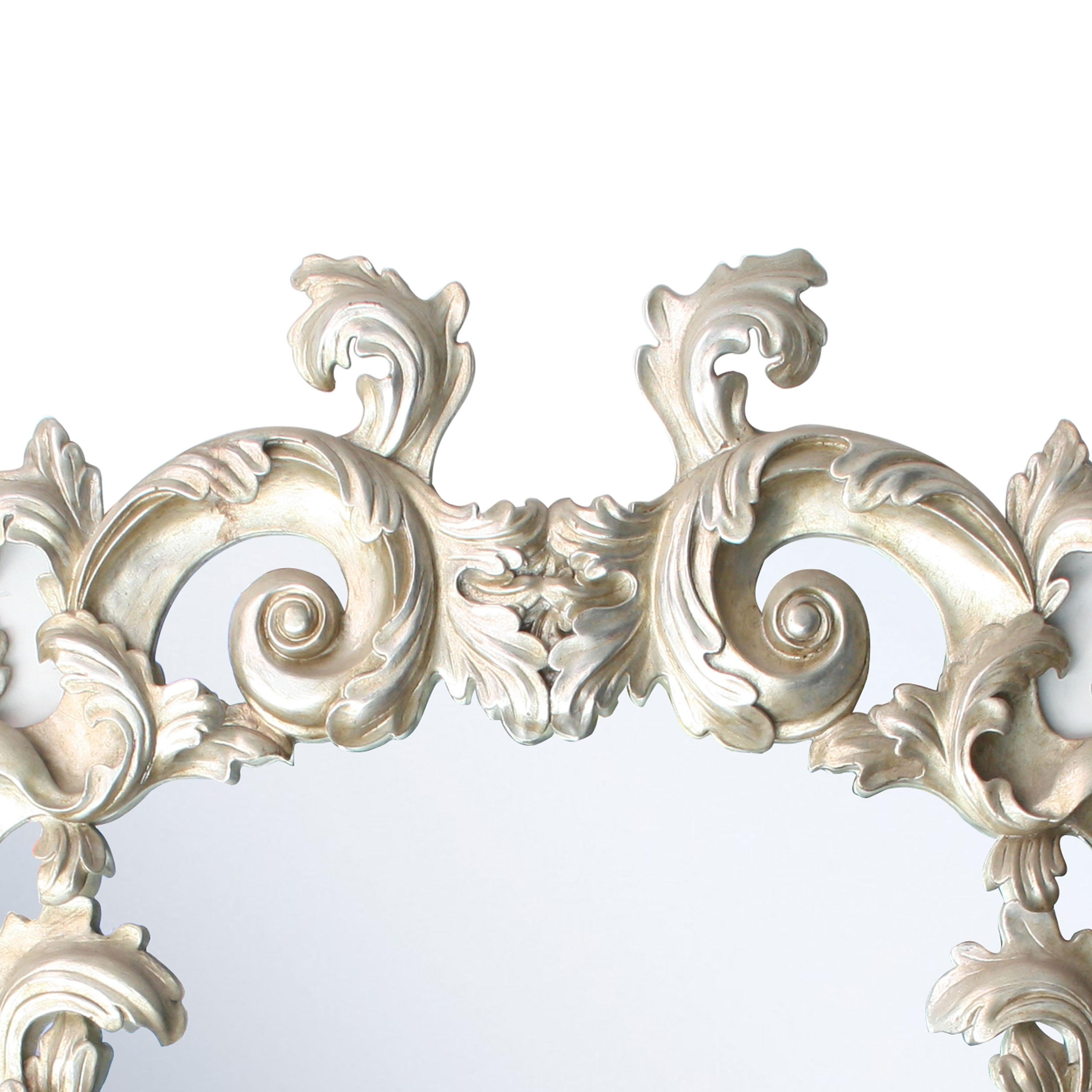 Handcrafted carved Chippendale style wood mirror covered in silver foil.
 