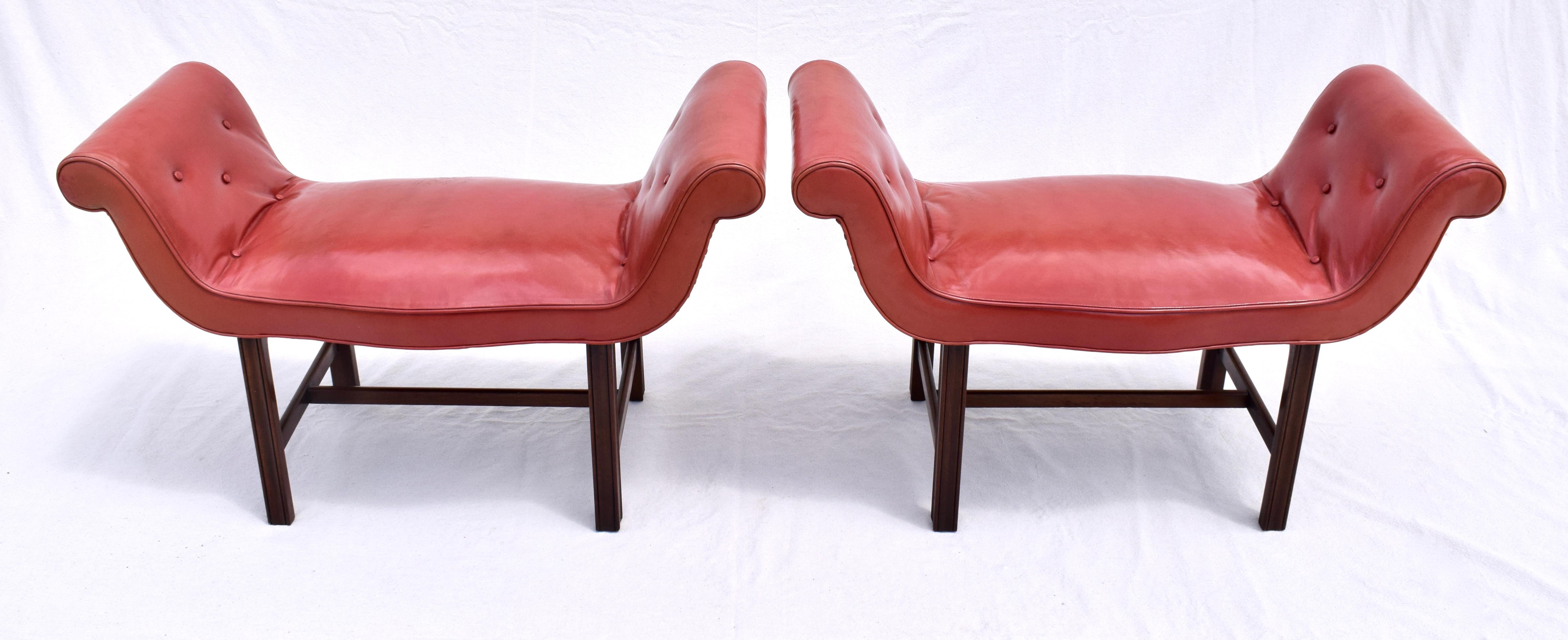 Exceptional pair of English saddle style mahogany H stretcher base Chippendale window benches with flanking scrolled arms in original Salmon leather upholstery & leather capped tacks surround. Early 20th century.