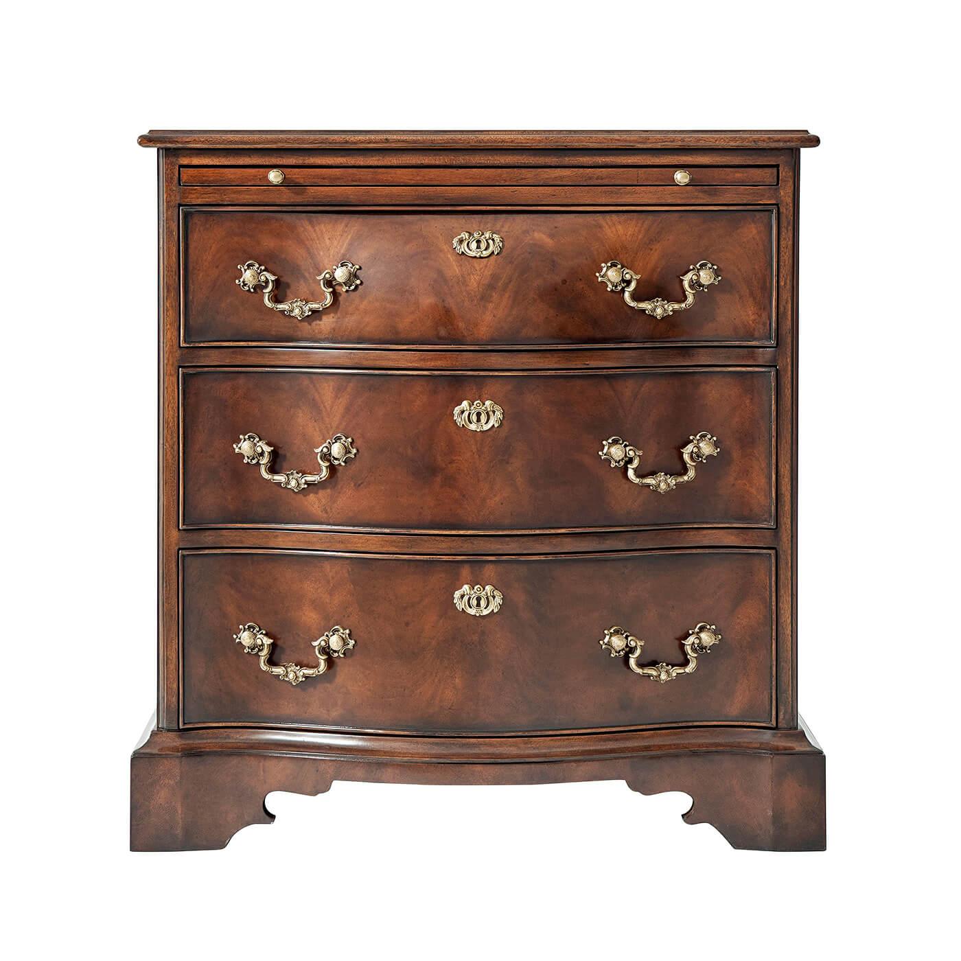 A mahogany bombay bedside chest of drawers, the rectangular molded edge top above a brushing slide with three shaped serpentine and graduated drawers below, applied with finely cast brass escutcheons and drop handles, on a plinth base with ogee