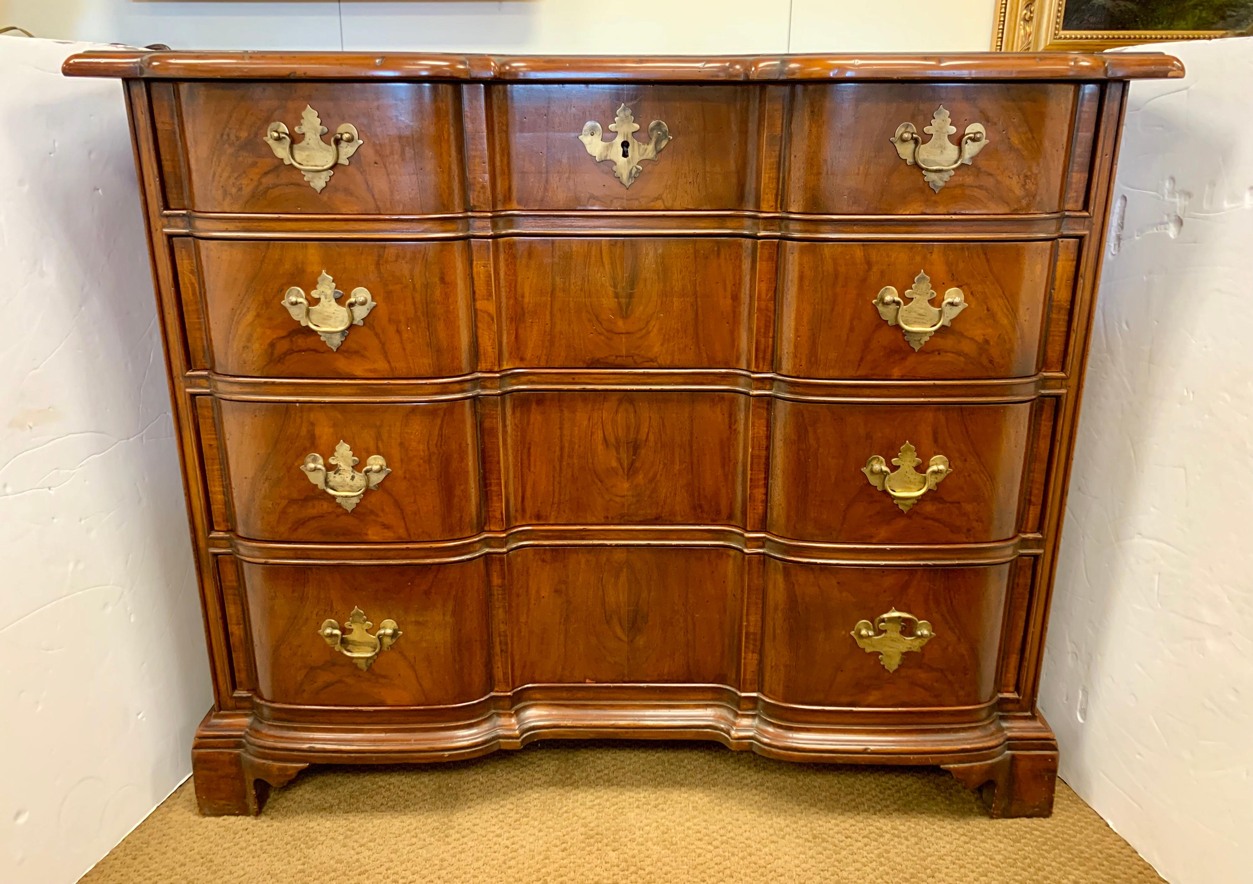 Handsome Chippendale mahogany chest with four spacious drawers with serpentine front. It rests on bracket feet and has all original brass hardware. It has a beautiful aged patina.