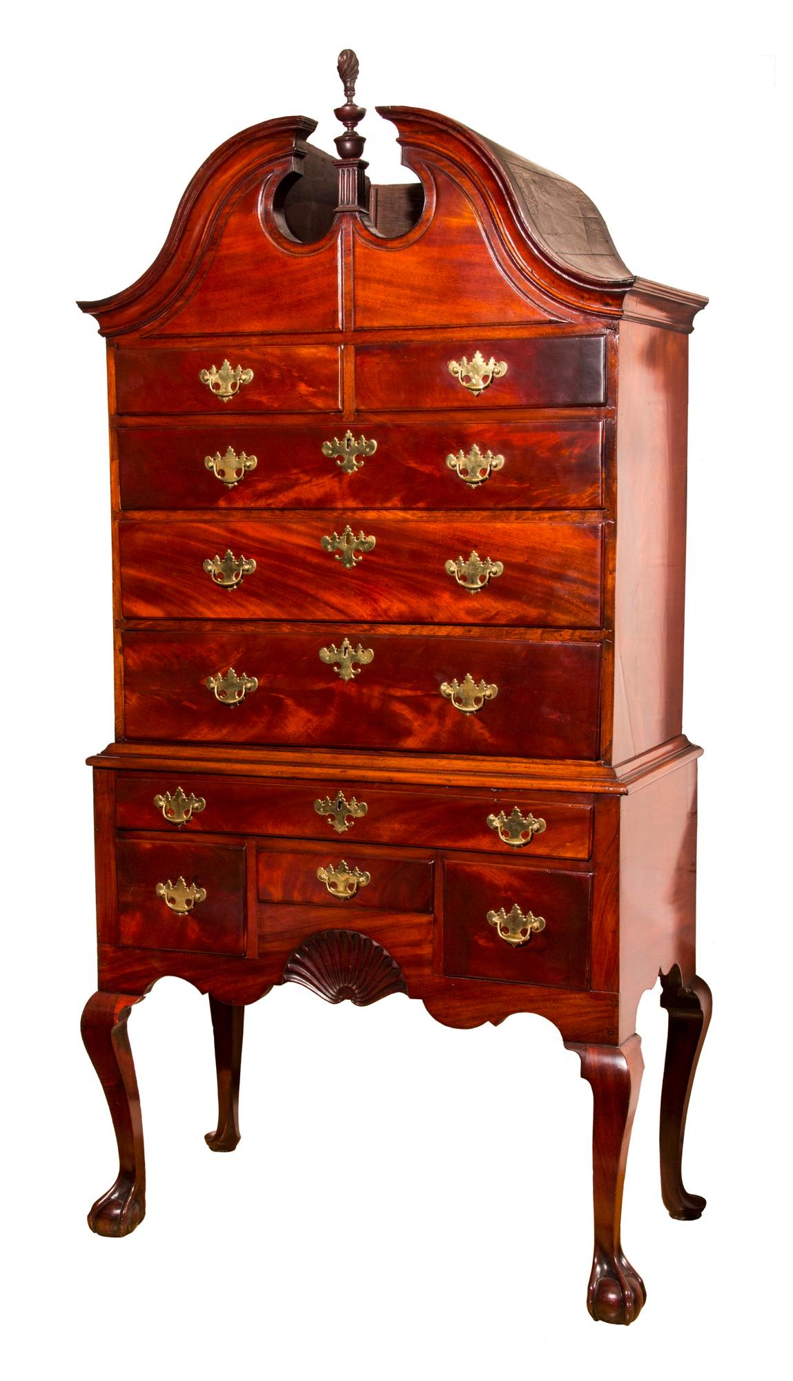 An early Chippendale mahogany bonnet-top highboy, with original finial, by the Townsend/Goddard School of Cabinetmakers, Newport, Rhode Island, circa 1765.Provenance: Descended through the John Olney family

Referenced: Yale University Rhode