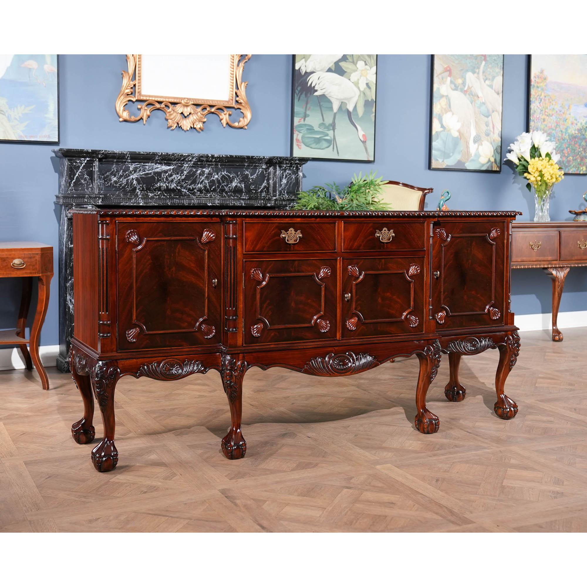 This Chippendale Mahogany Breakfront is produced in two sections to make moving and installation of the sections easier. The top section of the Chippendale Mahogany Breakfront features a pierced carved crest with removable finial. The four doors