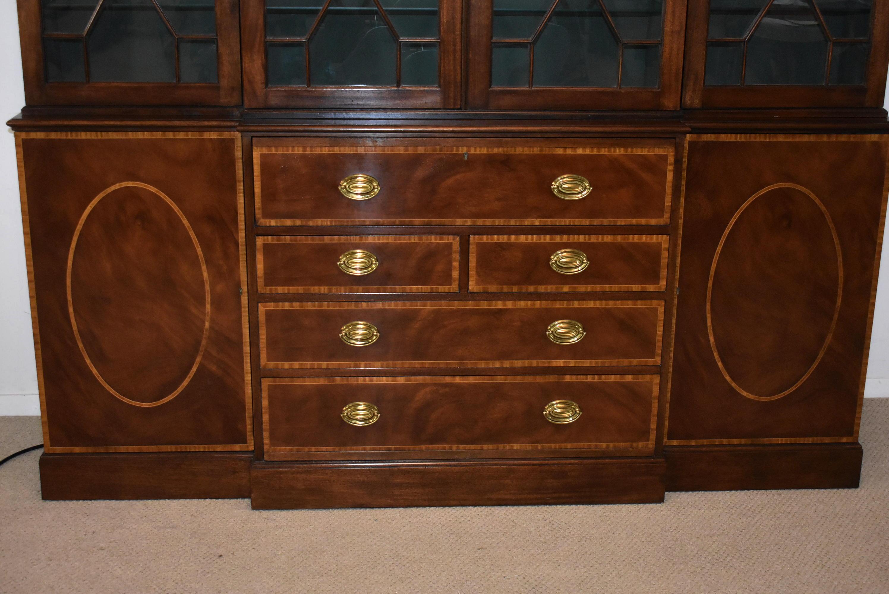 Chippendale mahogany breakfront secretary Collectors Edition by Baker. Flamed mahogany banded inlaid doors and drawers. Bent glass panels individually hand glazed into the doors. 3/8