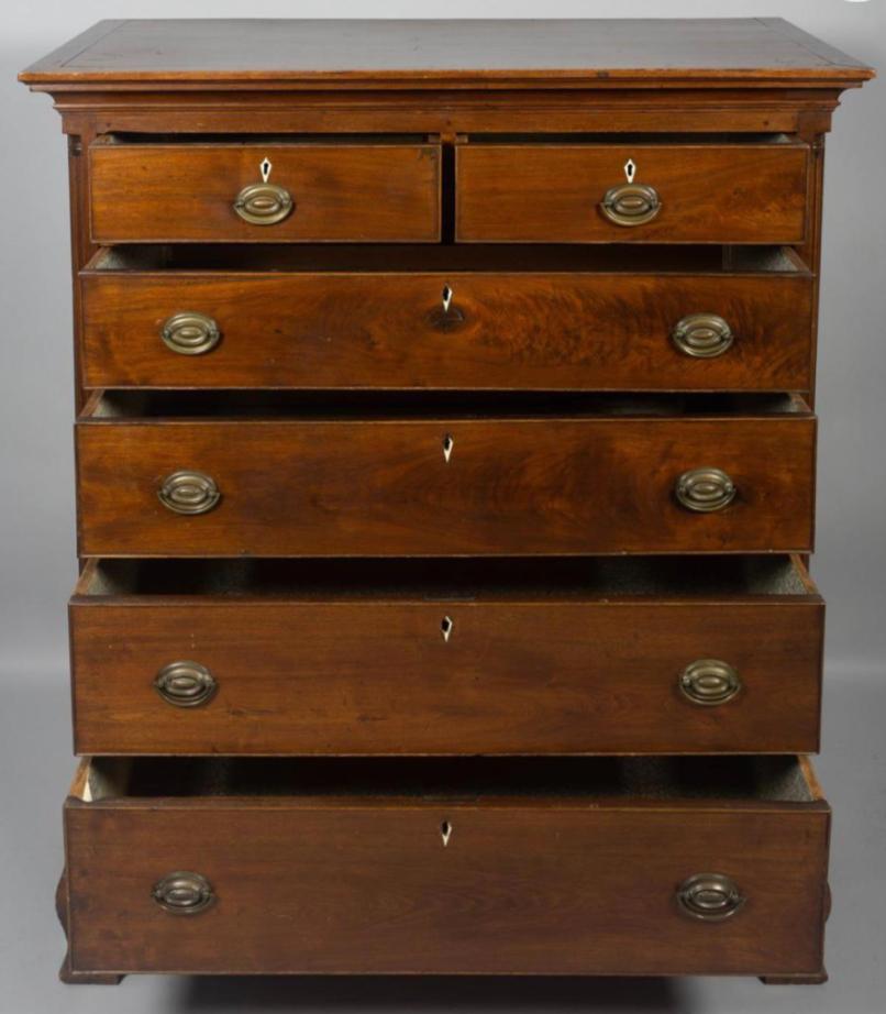 Mid-18th Century Chippendale mahogany chest of drawers with six drawers. Molded rectangular top above a conforming case fitted with two short drawers over four drawers applied at the angles with quarter columns on Ogee bracket feet. England,