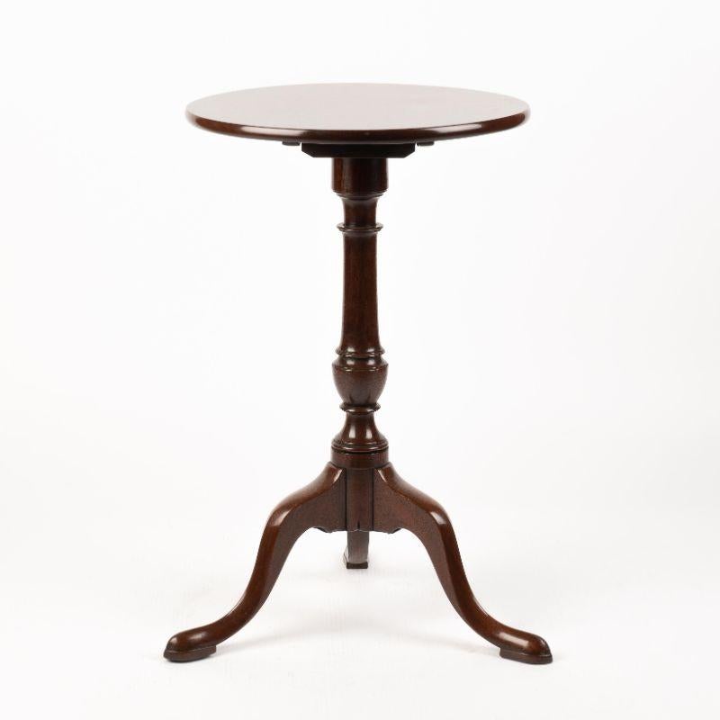 Chippendale mahogany circular top candle stand with a vasiform turned pedestal. The top rests on arched tripod cabriole legs terminating in pad feet.
English or American, circa 1770.