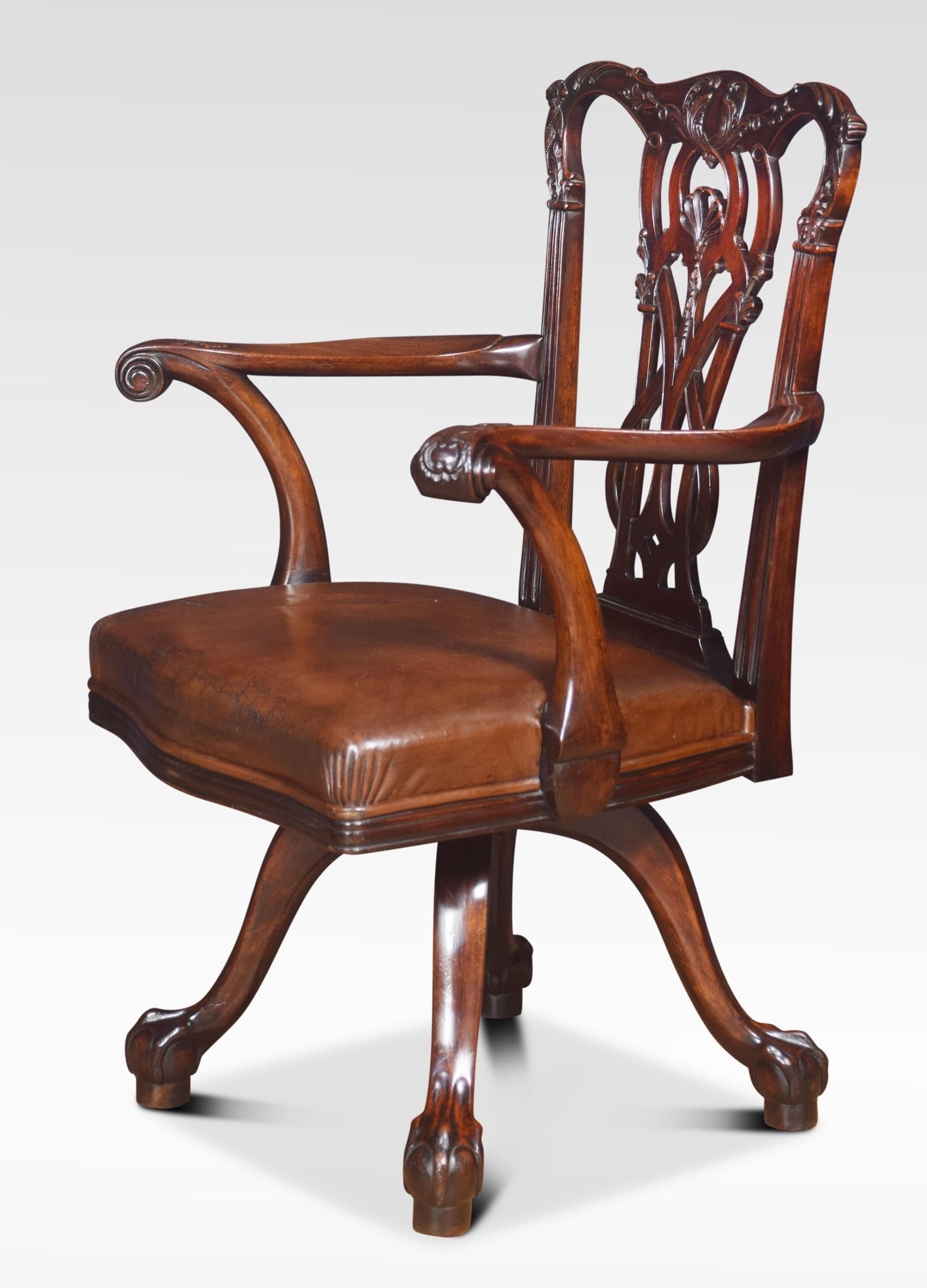 Late 19th century Chippendale style mahogany revolving desk chair. The carved and interlaced splat back above out swept arms and carved paper scrolls, above the serpentine leather seat mounted on an iron revolving mechanism. All raised up on four