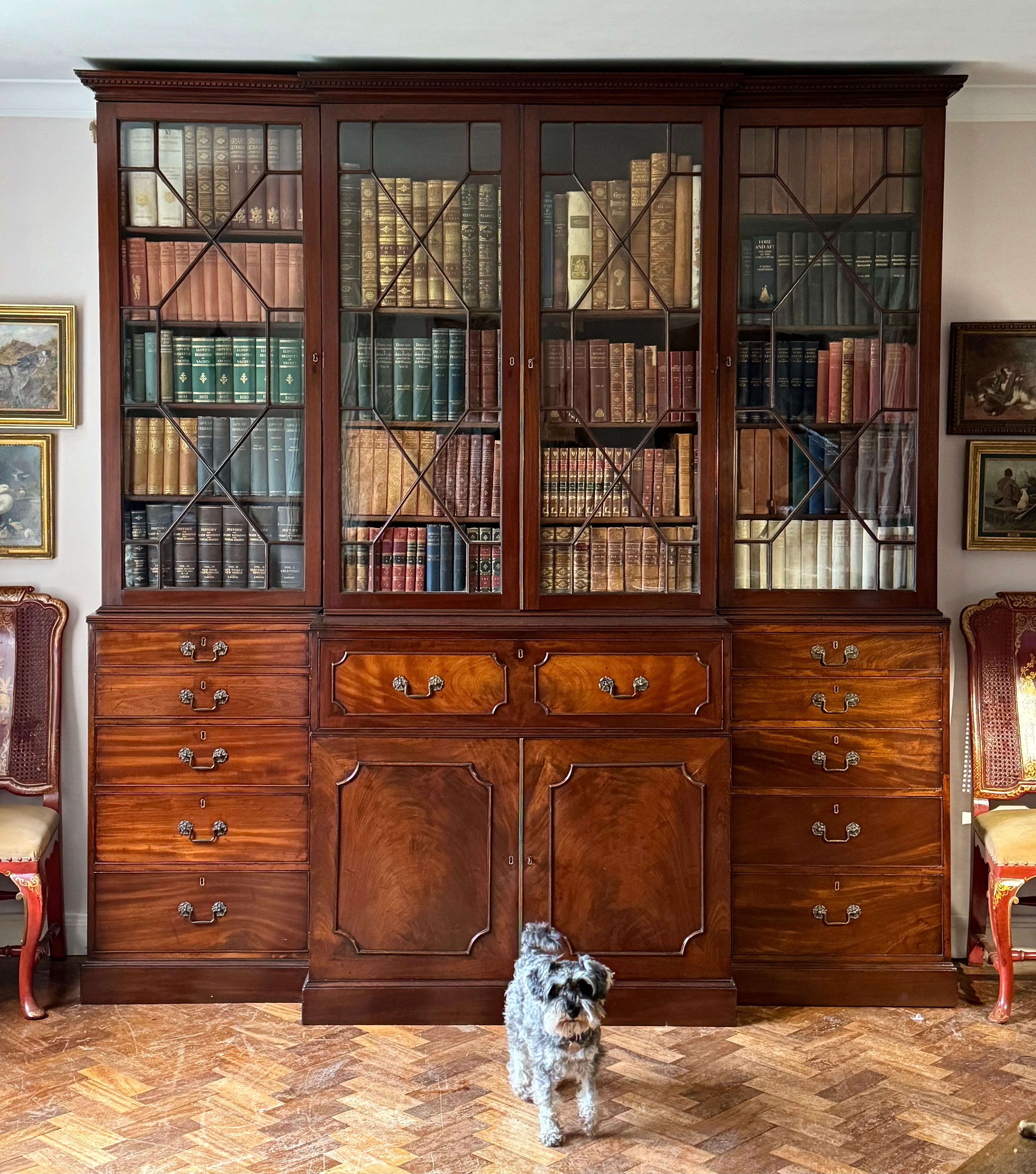 A classic Chippendale-period secretaire breakfront library bookcase in well-figured mahogany. Early-George III, circa 1760. Of excellent colour, patina, and condition throughout.

This fine and well-proportioned bookcase is composed of six sections