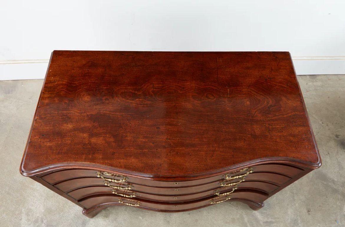 A very fine serpentine mahogany chest of drawers circa 1760 in the manner of Thomas Chippendale having a molded top over four drawers with a brush slide, resting on molded bracket feet. The overall quality of this chest is superb having muntin