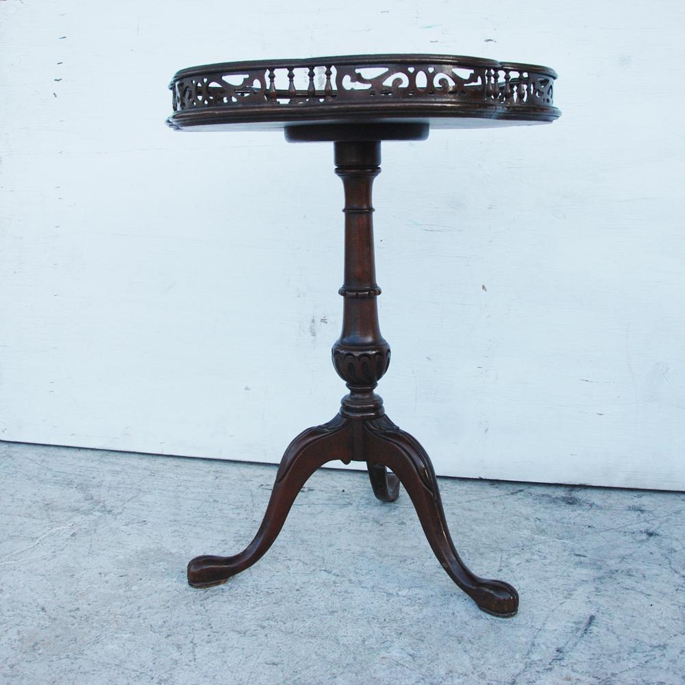 Georgian mahogany tripod table with decorative gallery edge

19th century tripod table with an intricate gallery around the edge. 
Cabriole legs.
  