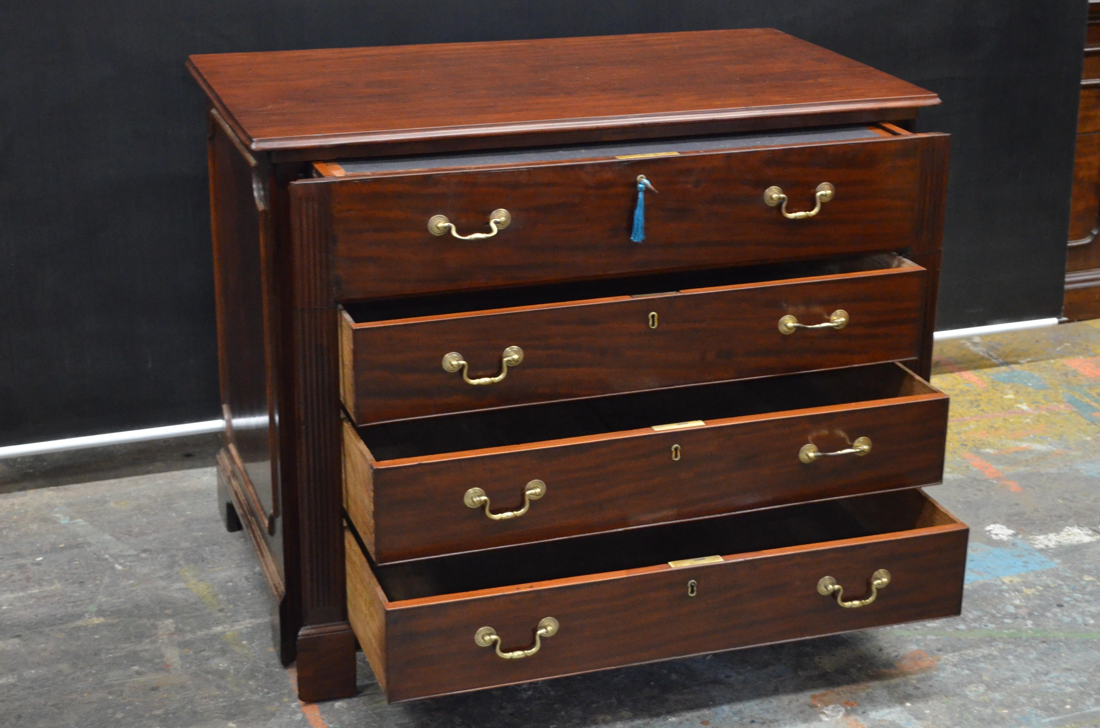 A Regal English Chippendale Metamorphic Chest having a Pull Out Writing Desk made in the Late 18th Century. The Georgian Chest has an unusual Faux Pair of Cabinet Doors on the back, so that the Metamorphic Desk can be used in the center of the