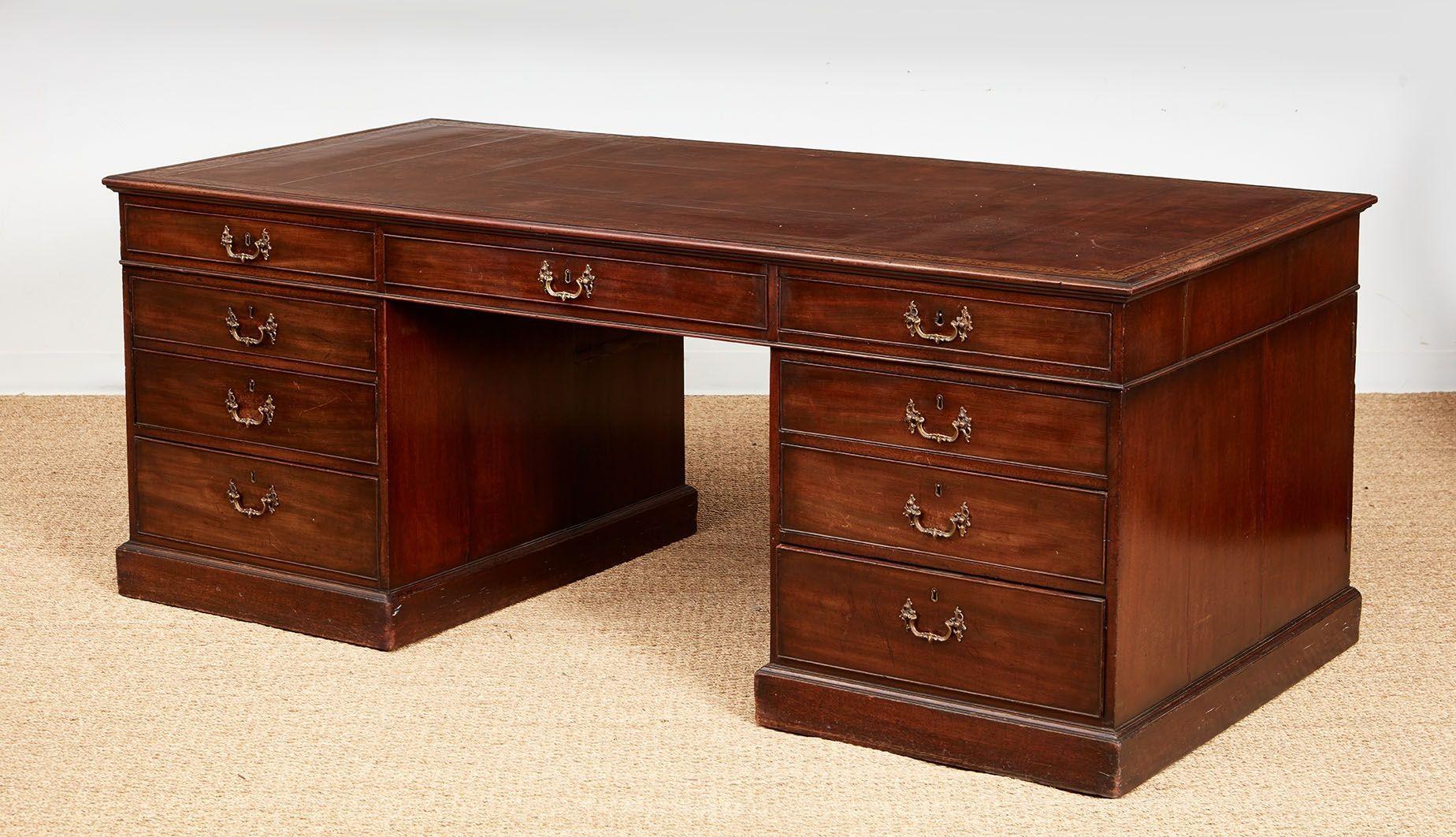 Very fine George II mahogany partner's desk in the manner of Thomas Chippendale.  Possessing a large work surface with an inset gilt tooled brown leather top over a row of drawers to both faces on the frieze, over generous pedestals, each with a