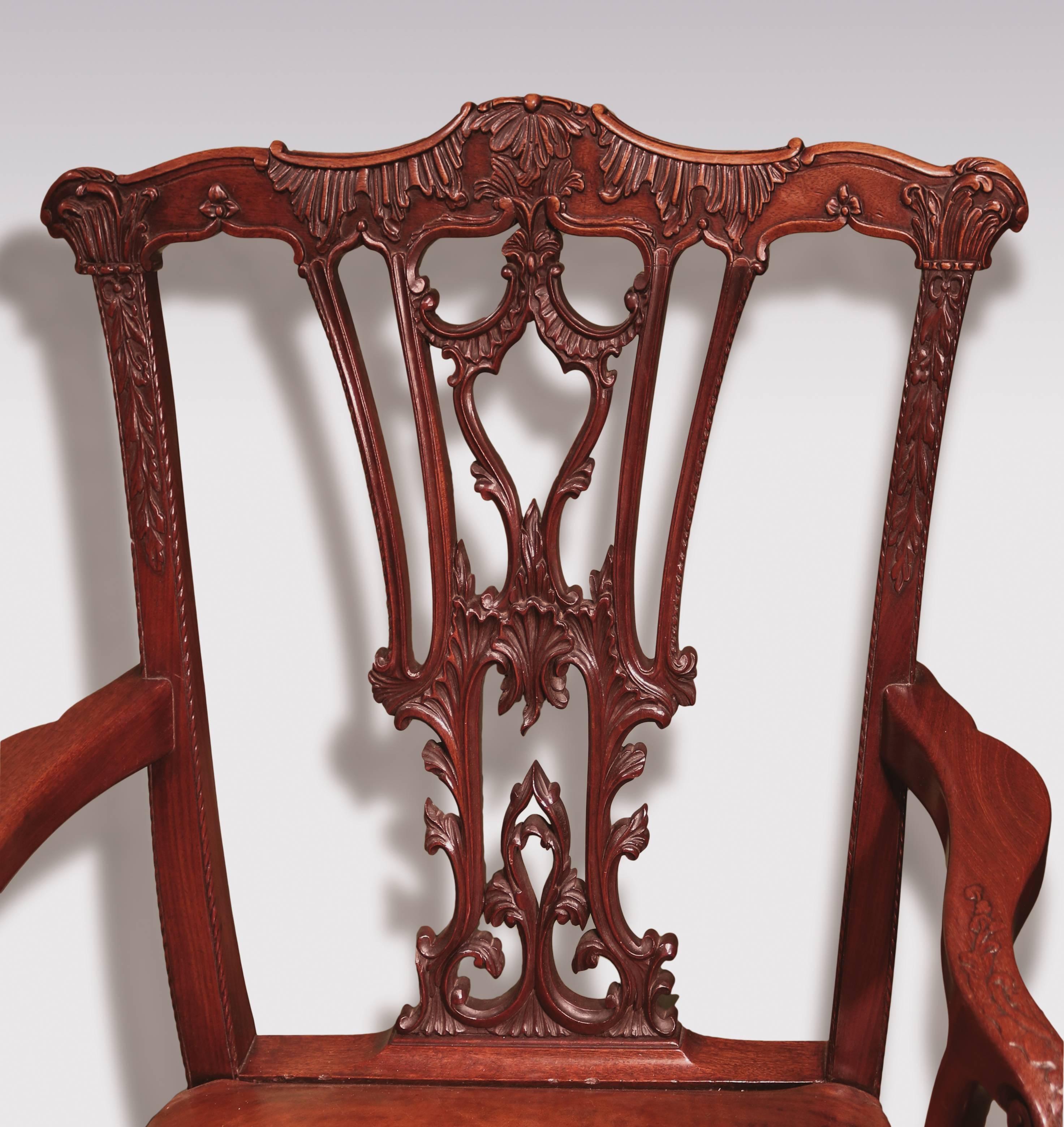 A mid-18th century Chippendale period mahogany armchair, having shaped top rail with intricate acanthus scroll carved pierced splat and carved scrolled outswept arms, above leather stuff-over seats, supported on square chamfered legs with carved edge