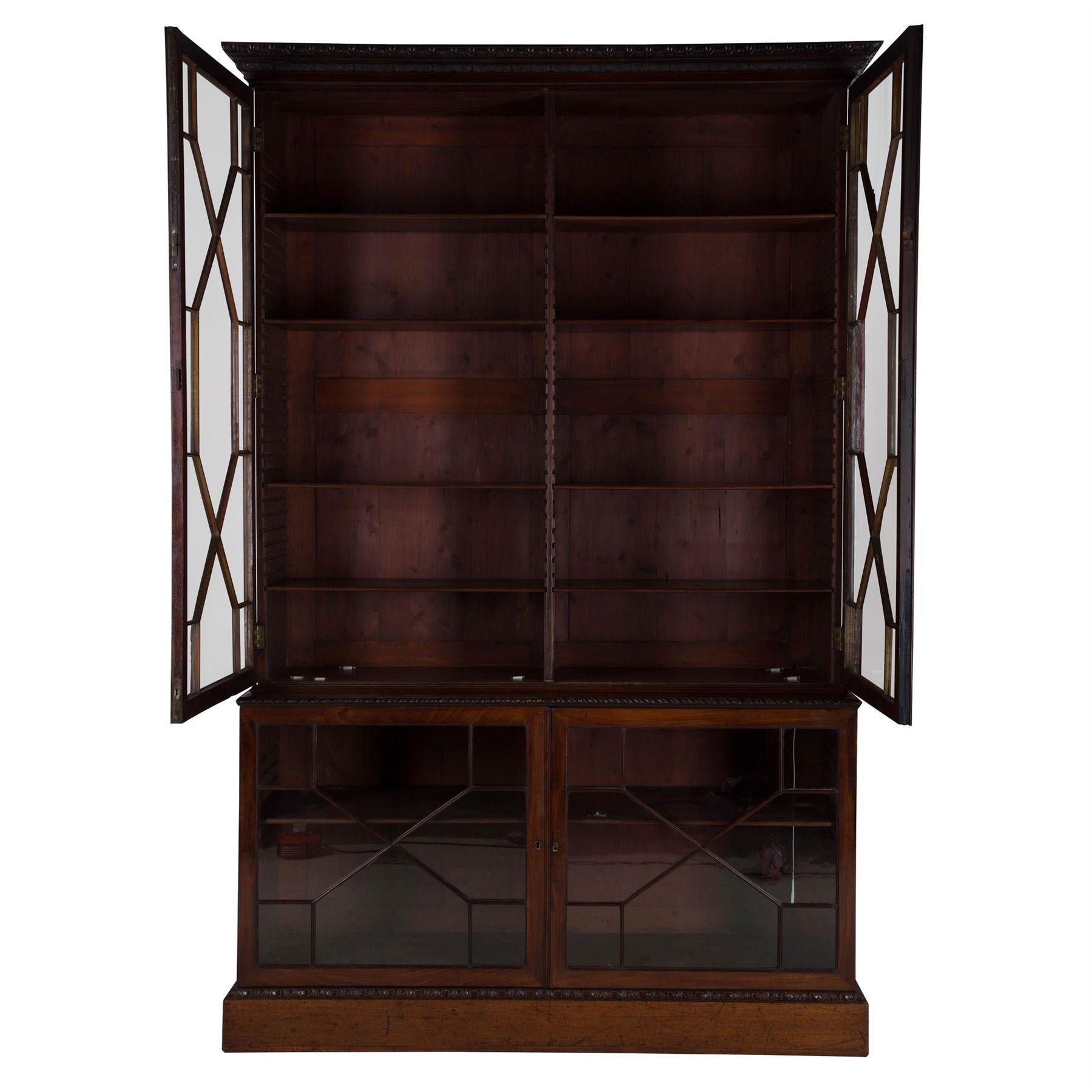 An 18th century Chippendale period mahogany bookcase or display cabinet, with astragal doors and carved moulding.