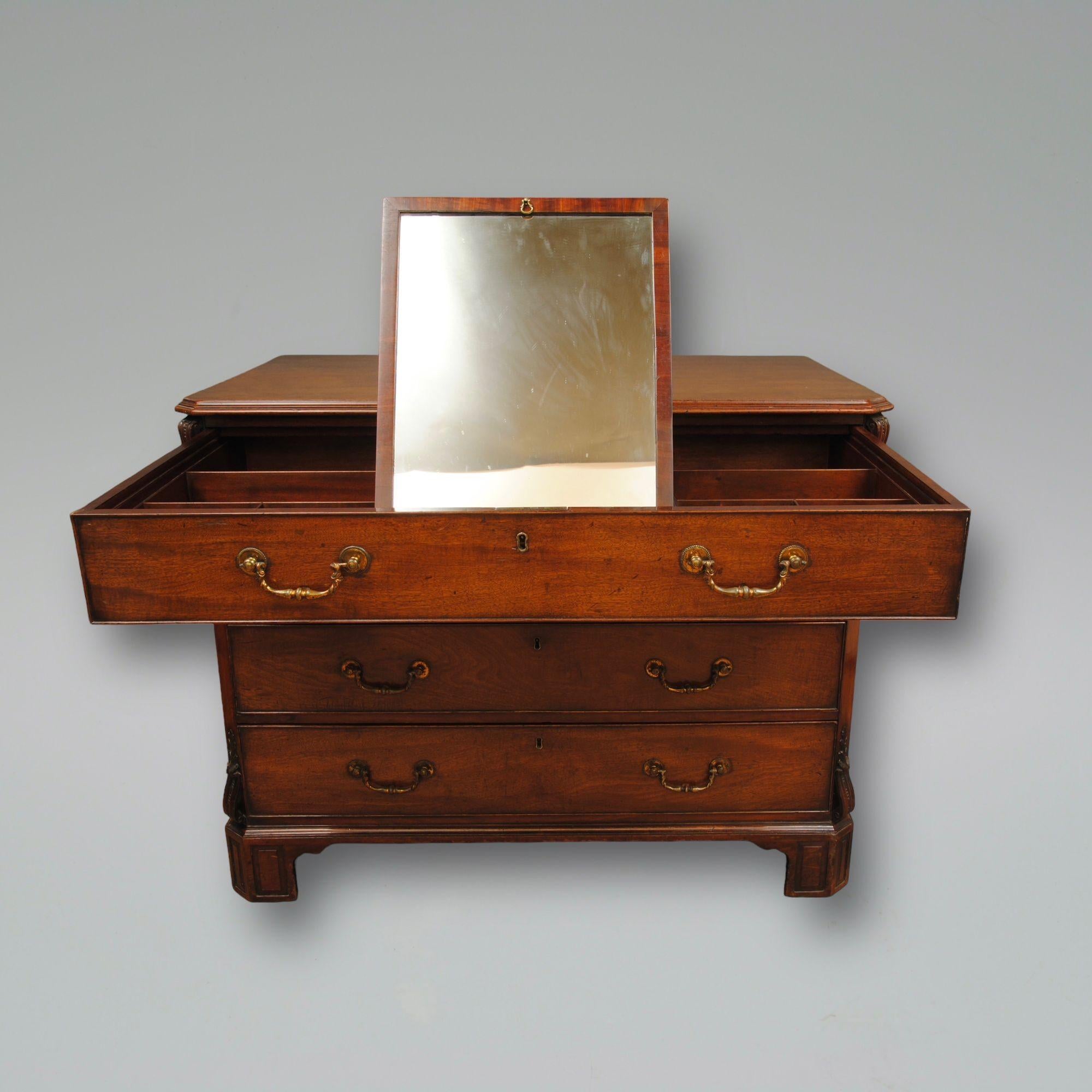 A fine 18th century mahogany gentleman's dressing chest. 
The top drawer with a baized slide opening to reveal a fitted interior with a mirror and two hidden drawers at the back.
The original brass handles on the drawer fronts retain some of the