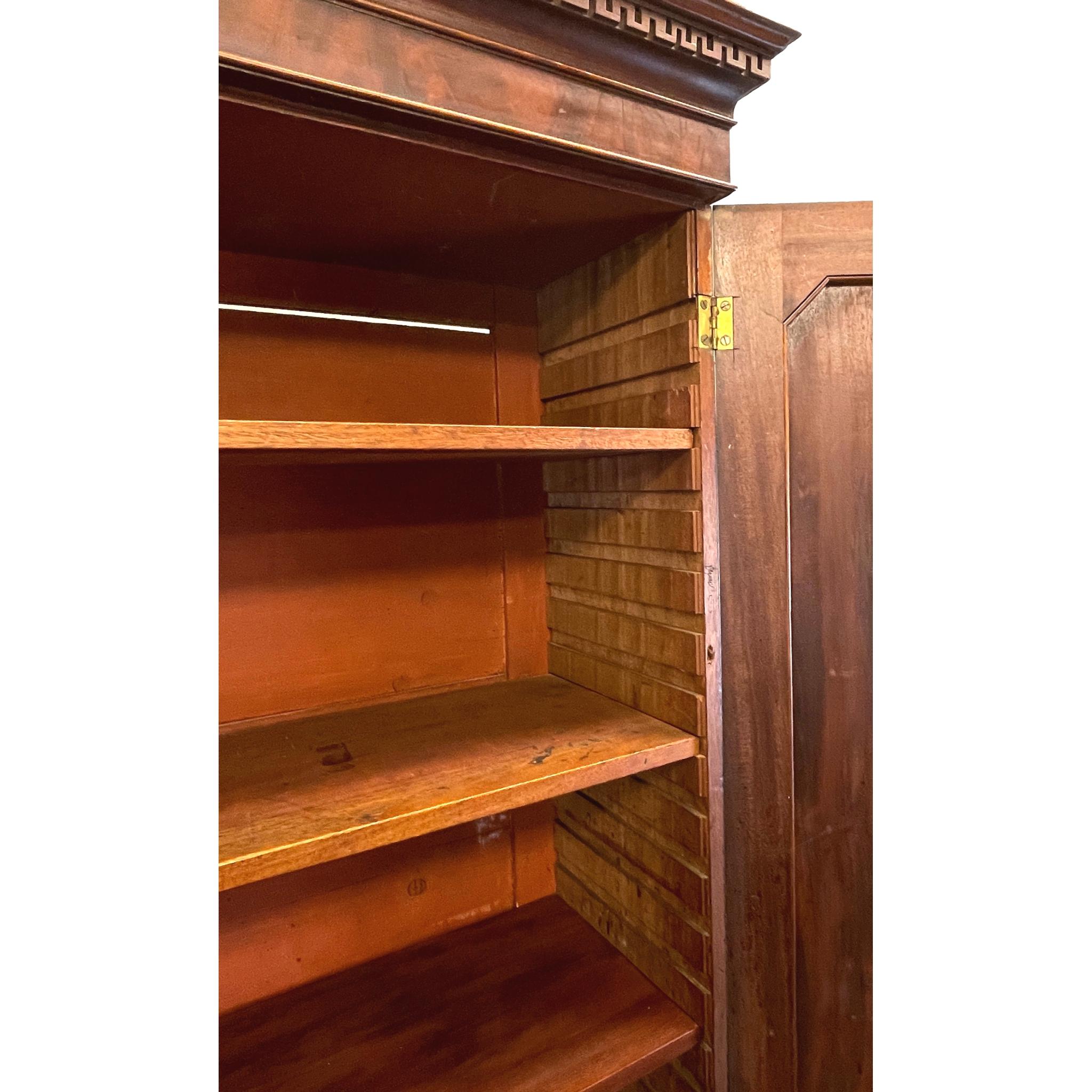 An extremely good quality mid-18th century Georgian mahogany
Chippendale period library bookcase, or cabinet, having Greek
Key moulded cornice over superbly figured panelled cupboard
Doors enclosing three adjustable shelves over secretaire