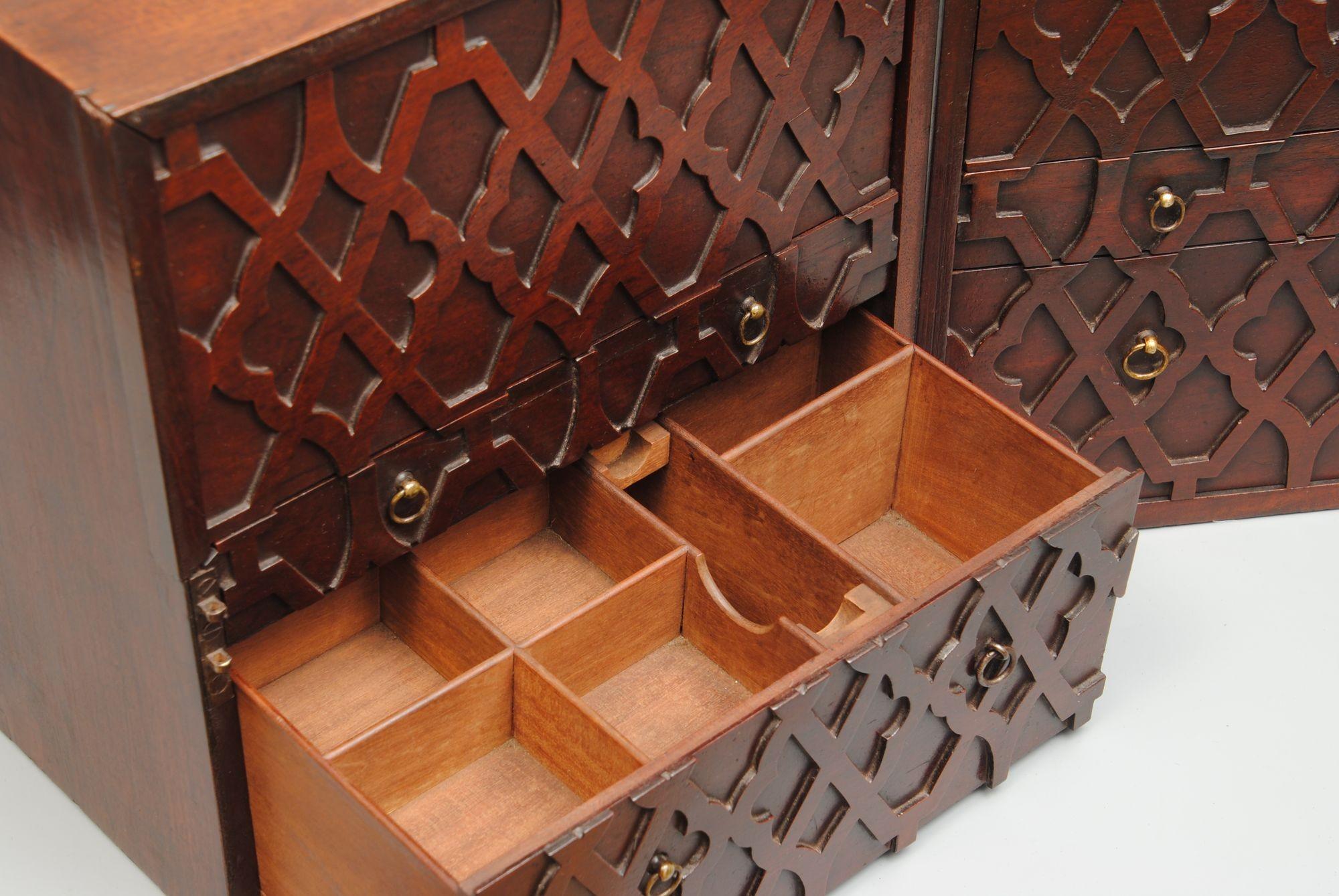 A rare 18th century Chippendale period mahogany apothecary box with two brass carrying handles to the top, the box opens to reveal blind fret gothic design to the drawer fronts and sliding covers. The slides reveal segmented interiors for bottles