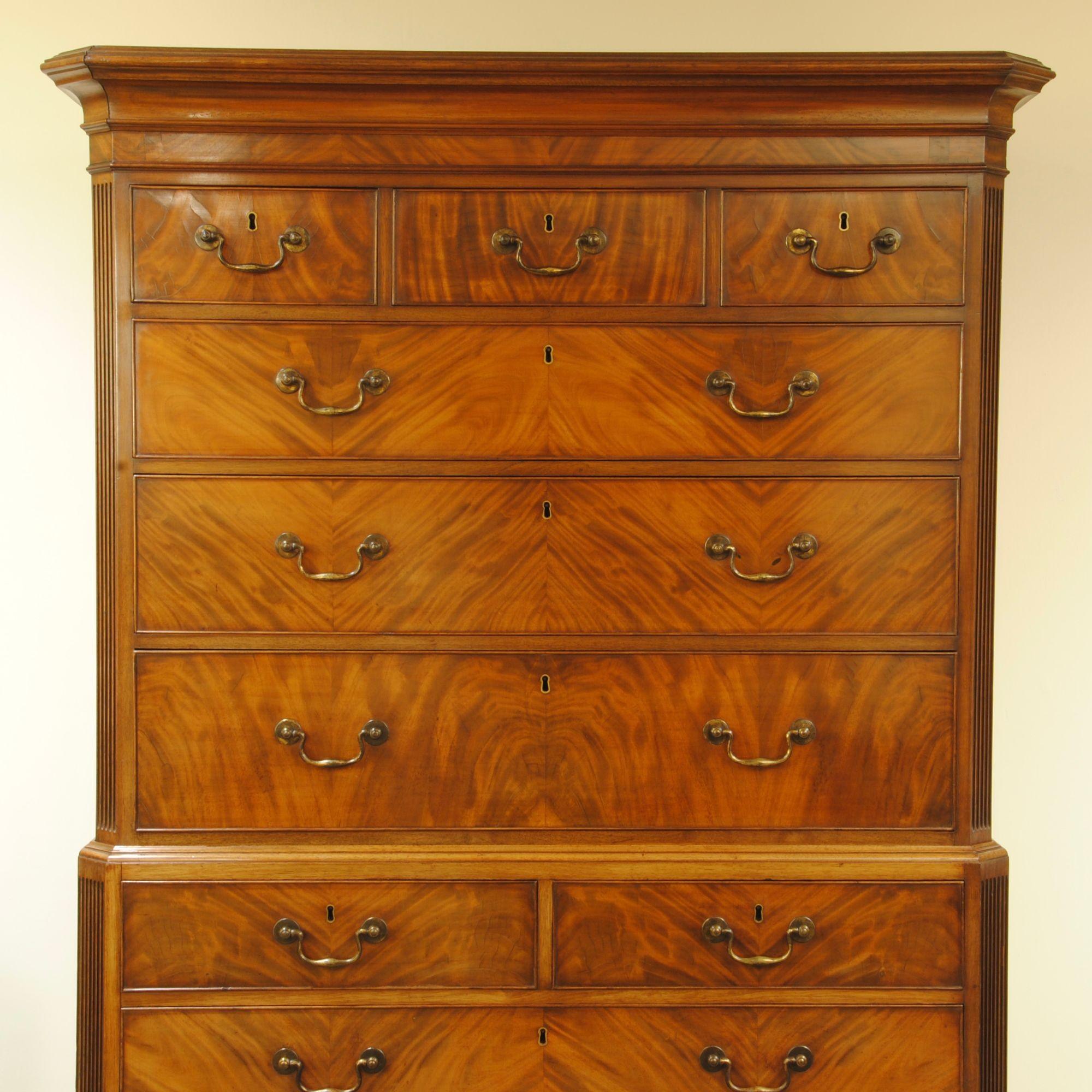 A fine 18th century flame mahogany tallboy, the quarter cut veneers are matched across the whole front creating a herringbone pattern. Double reeded canted corners, ogee bracket feet, and the original brass handles make this a superb example