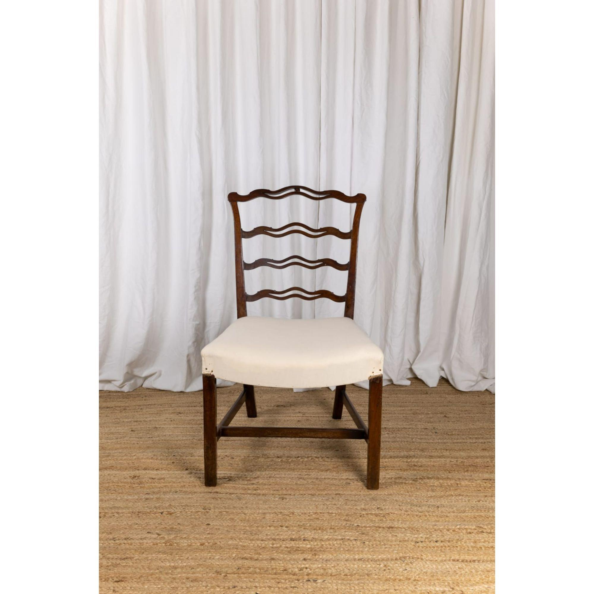 Chippendale period ribbon back side chair, circa 1780

A generously scaled George III 'ribbon' back mahogany side chair. Ladder back with an upholstered seat, standing on square legs united by an 'H' stretcher. English, circa 1780.

Dimensions:
