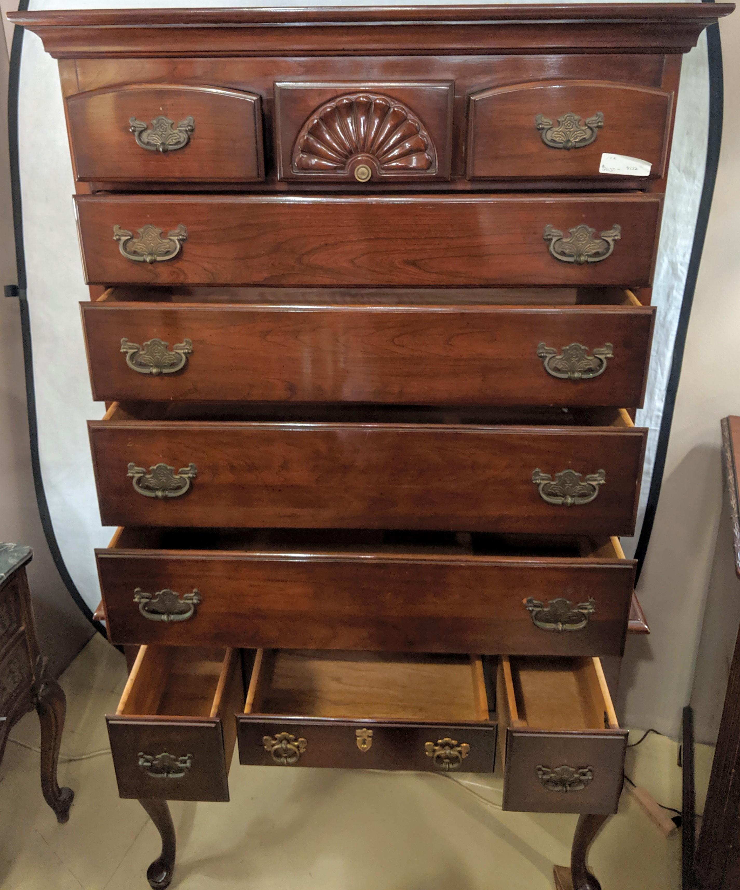 Chippendale Queen Anne two-piece chest on chest by Monitor Furniture Company. On sleek slender ball and claw cabriole legs with a center drawer flanked by a set of side drawers the low boy supporting an upper case of seven drawers three over four.