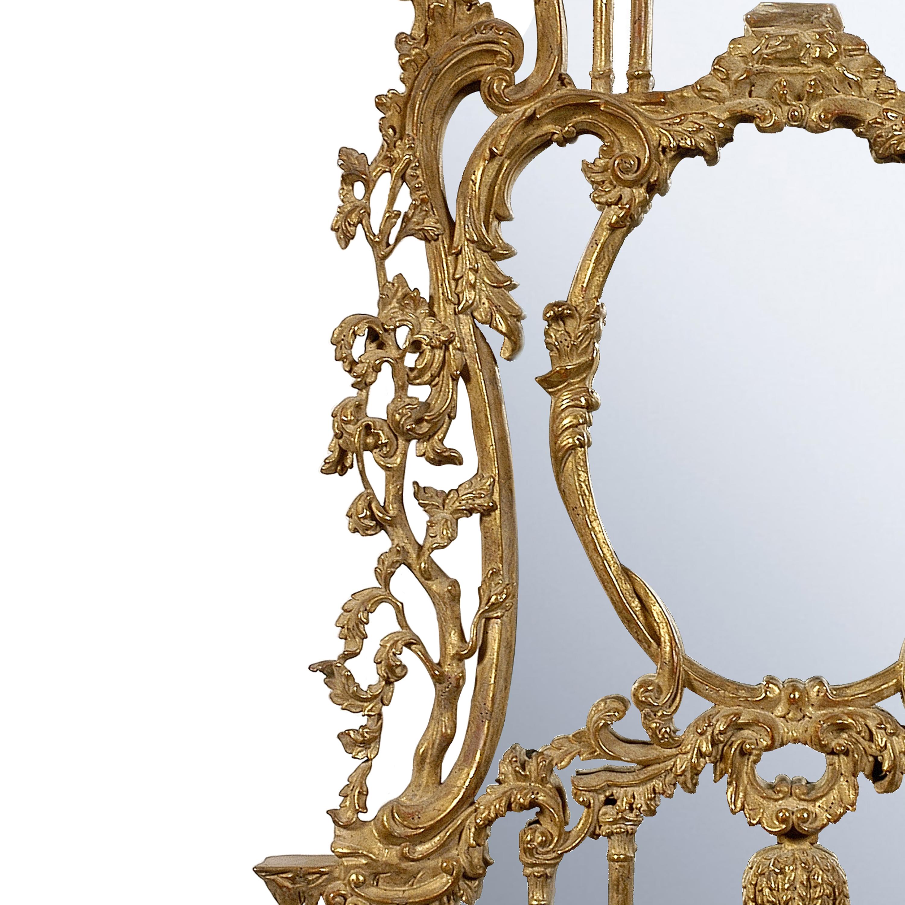 Handcrafted carved Chippendale style wood mirror covered in gold foil.