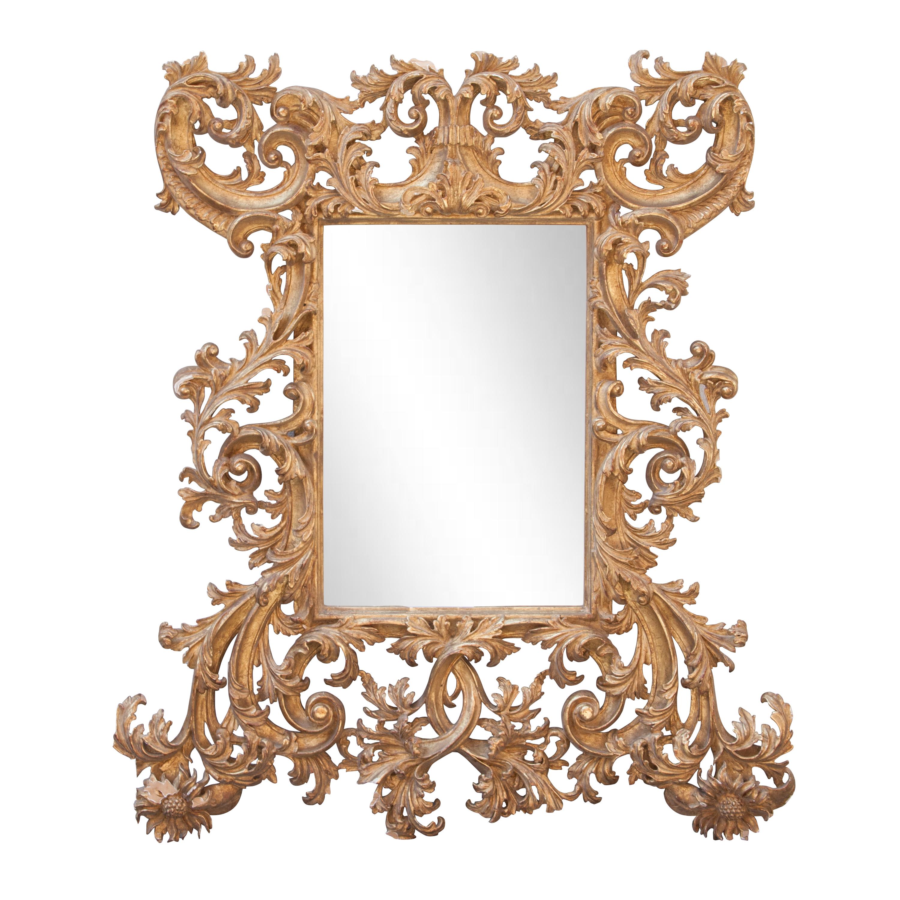 Handcrafted carved Chippendale style wood mirror covered in gold foil.