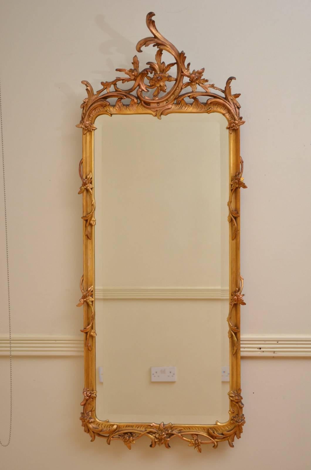 Sn4339 Turn of the century Rococo design gilded pier mirror, having original bevelled edge glass in scroll, rocaille and flower decorated frame, all in home ready condition. c1900
H54