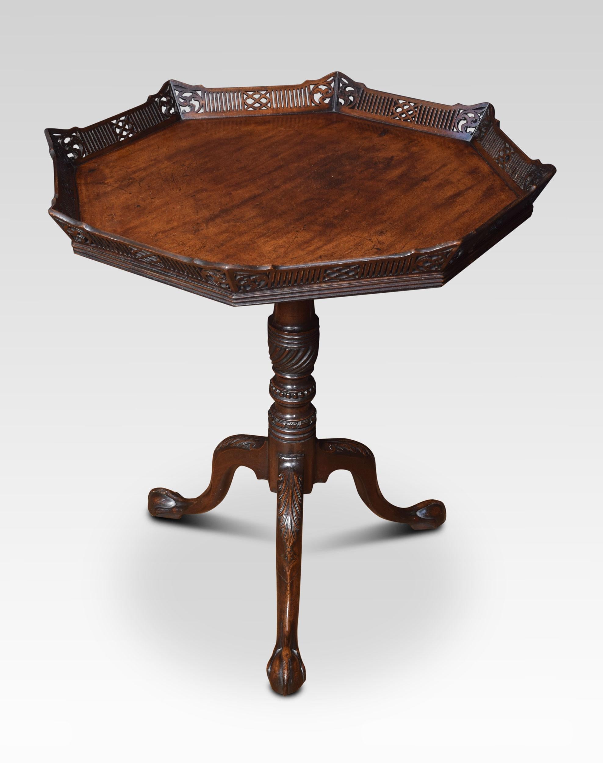 Chippendale revival mahogany silver table with a shaped top having ornately carved, scrolled fretted gallery, supported on a turned carved column with three slender cabriole legs.
Dimensions:
Height 32 inches
Width 31.5 inches
Depth 31.5 inches.