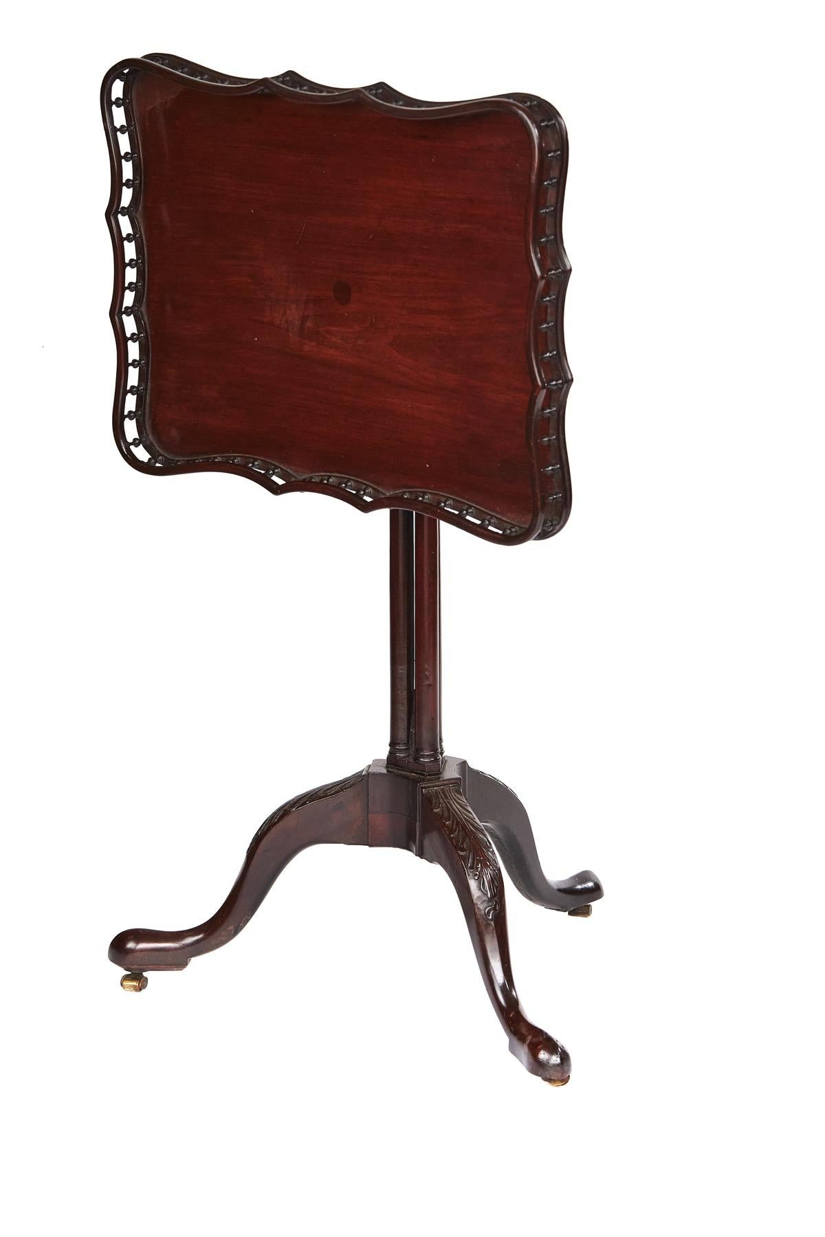 Chippendale Revival Mahogany Tip Up Tray top Table
circa 1900
Shaped Mahogany Tray top with Turned Gallery
Brass Catch Releases tip up top
Cluster Column Pedestal,
Tripod Leg base with carved leaf detail on knees,
Brass Castors
Recent Polish.