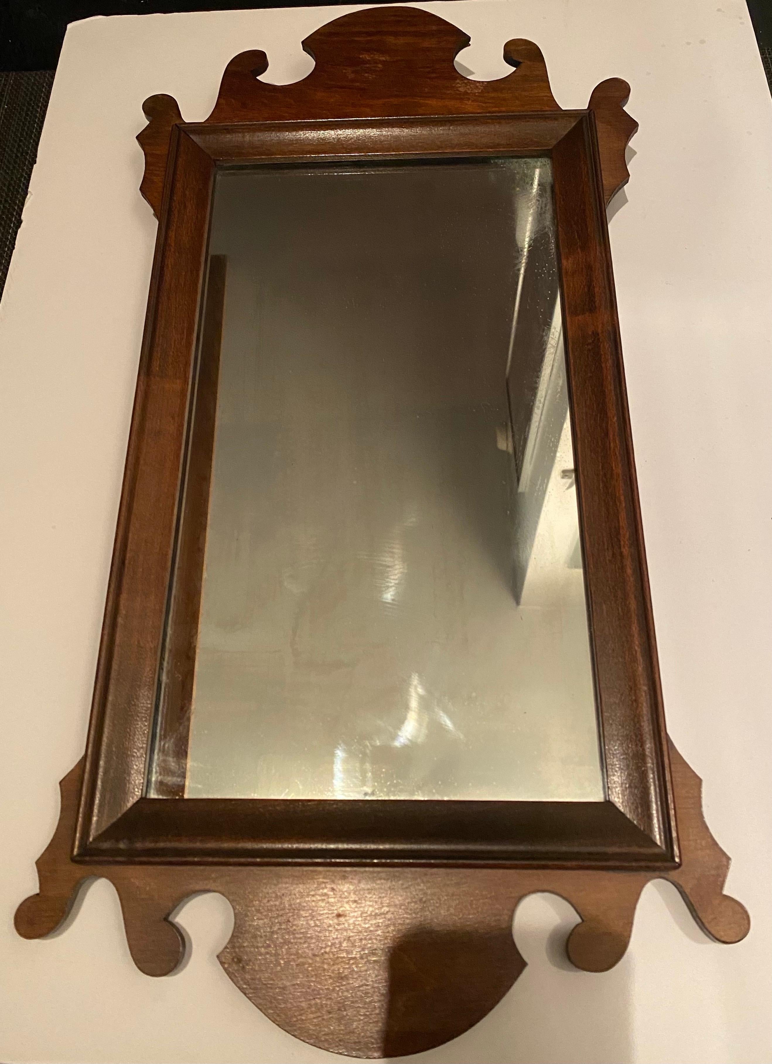 An antique period mahogany Chippendale Revival wall mirror. USA, circa 1920.

Includes original backing and hanging wire.

Dimensions: 22 H x 11.5 W x 1.5 inches D.


