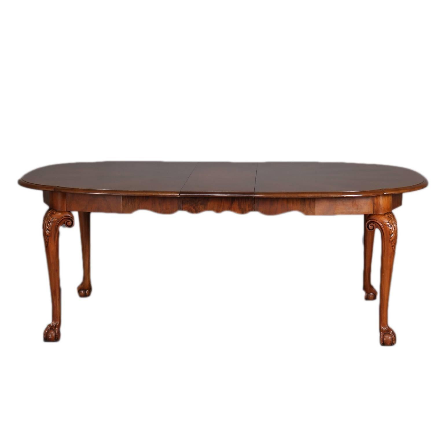 Chippendale School dining room set by Schmeig & Kotzian, Inc. New York features flame mahogany table and six chairs; table with banded top, scalloped skirt and matching flame mahogany and banded with six 12.75