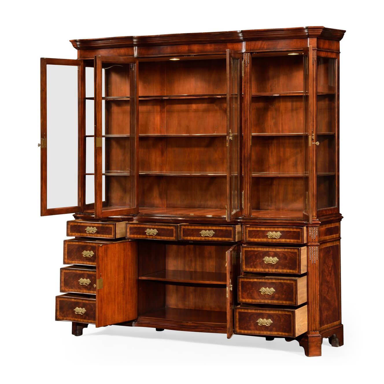 Large double fronted crotch mahogany and crossbanded china cabinet, the serpentine architrave followed by the curve of the glass below in the four doors. Adjustable glass inset shelving within. Range sensitive lighting with touch-controlled dimmer.