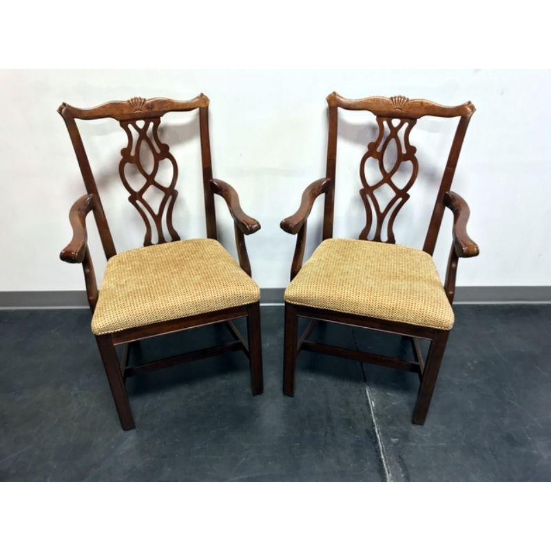 Pair of dining armchairs in the Chippendale style by Cresent, of Gallatin, Tennessee, USA. Likely made circa 1980s. Made from maple, or other hardwood, with cherry color stain, straight legs and stretcher base.

Overall: 23.5 W 22 D 39.5 H, Seats: