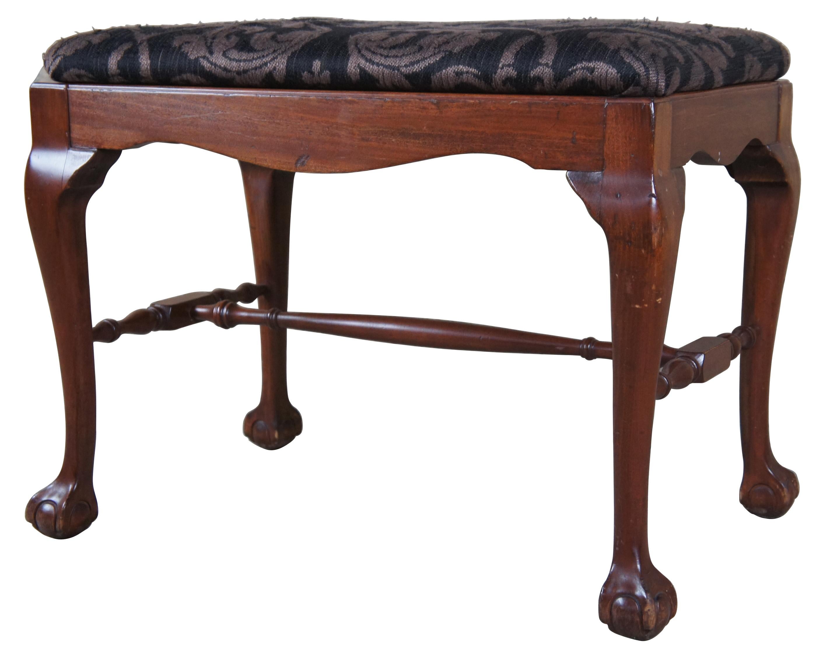 Vintage damask upholstered mahogany stool or bench. Features Chippendale styling with four legs connected by an H stretcher and ball and claw feet. Measure: 24