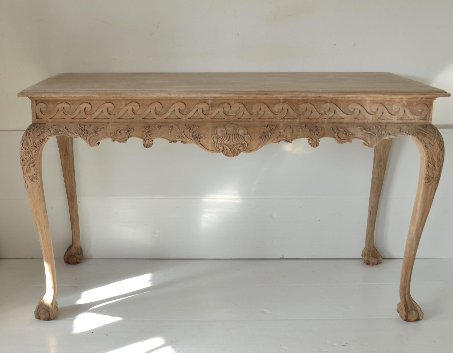 Fabulous carved mahogany console or serving table.

The piece is a good quality 20th century reproduction that we have recently bleached. It has created great distressed look.

The original 18th century table was probably Irish.

Difficult to