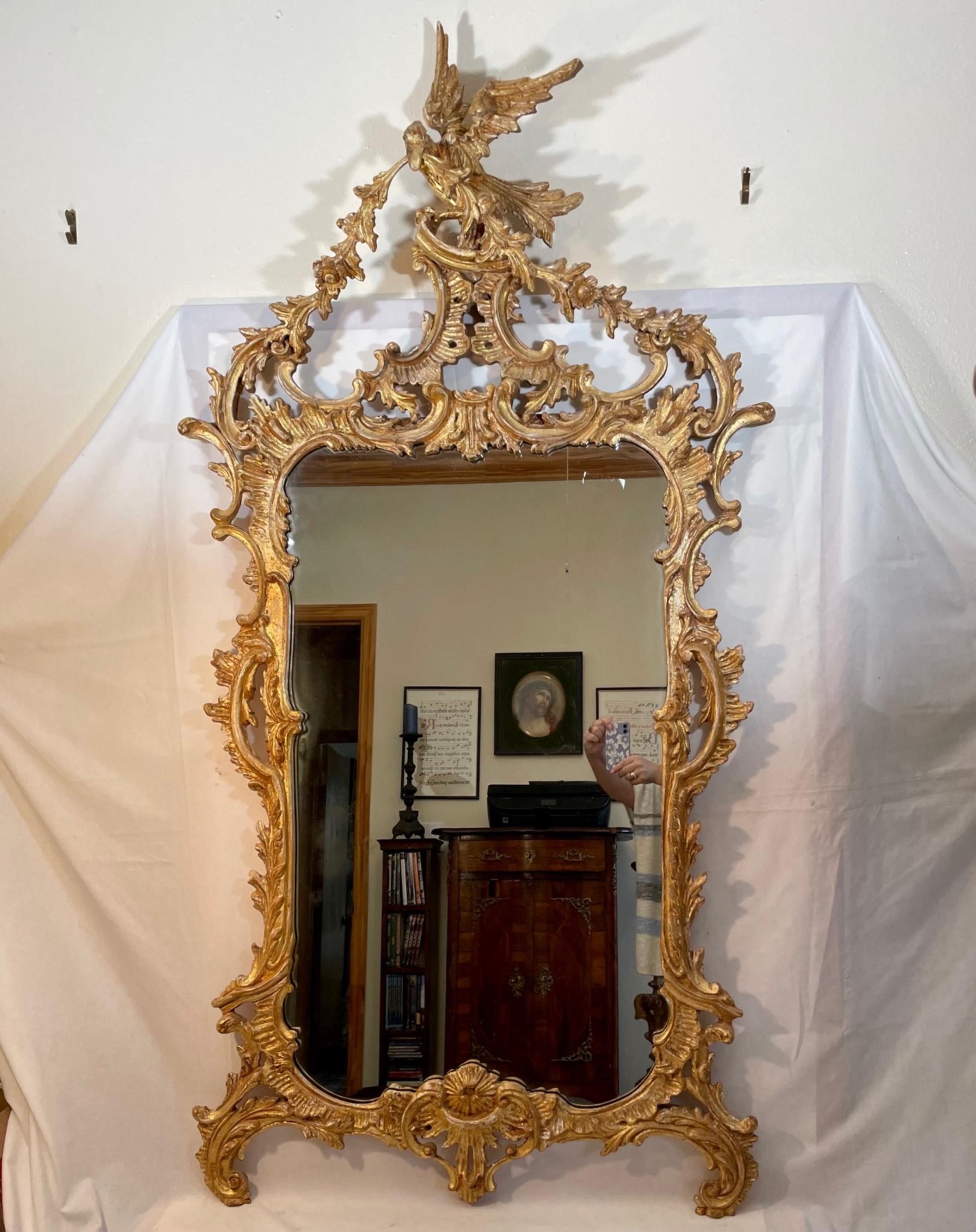 Chippendale style carved chinoiserie giltwood mirror.

Lavish ornately hand carved Thomas Chippendale style large wall mirror. The Chinese inspired decor is beautifully gilded. Refined delicate ornaments surround the mirror plate. The frame is