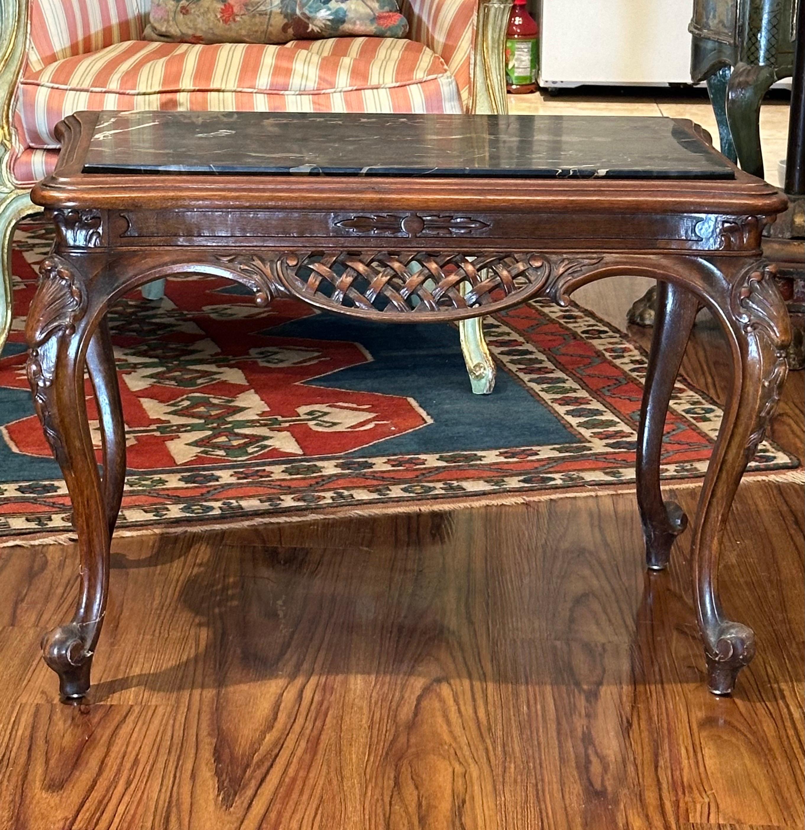 Chippendale Style Carved Mahogany and Marble Top Coffee Table

Magnificent marble top Mahogany coffee table with heavily reticulated foliate scrolled apron.  Sculpted on all sides for a stunning three dimensional effect. Four gracefully cabriole