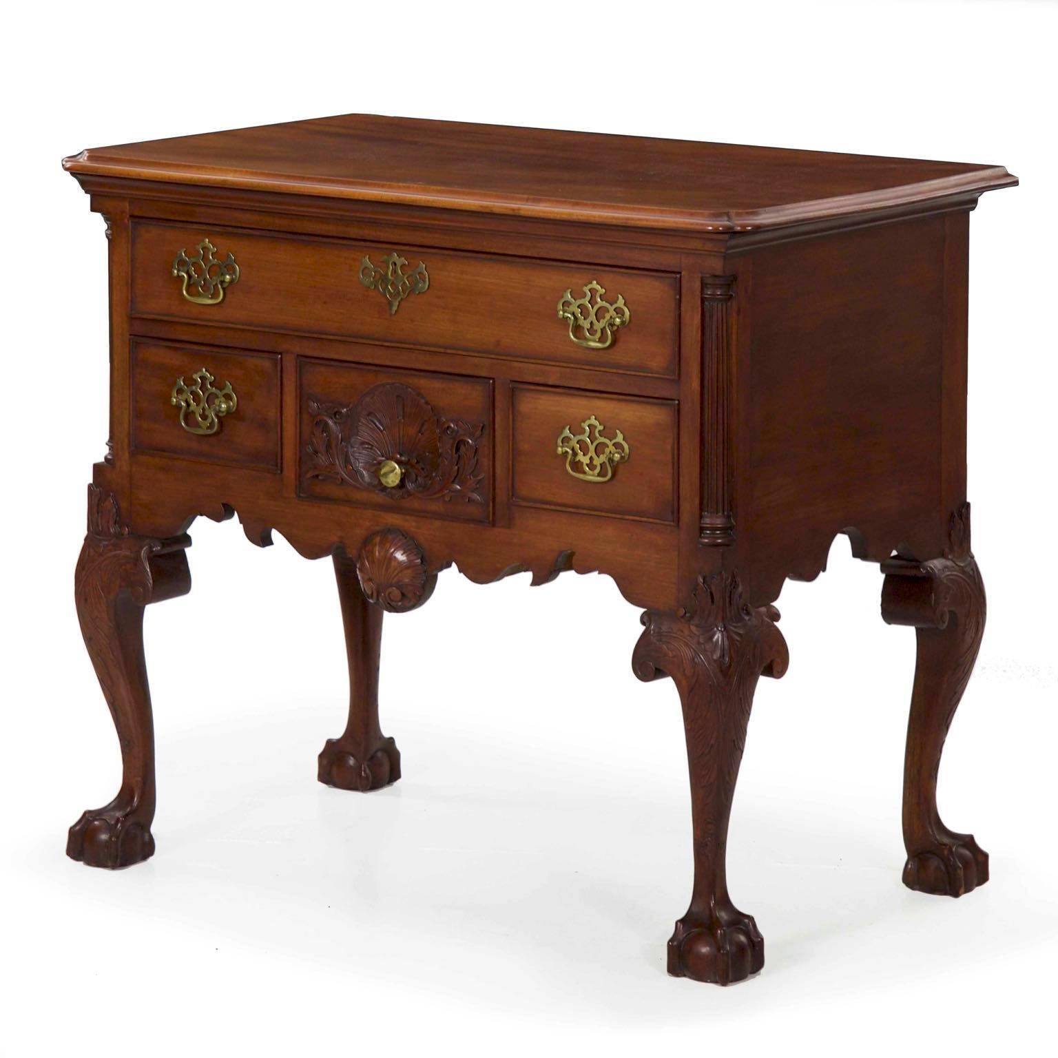 This is a beautifully handmade reproduction Chippendale lowboy chest of drawers in the Philadelphia tradition. Crafted out of solid mahogany, the top is inverted in the front corners with integral thumb molding, this projecting over the cove molding