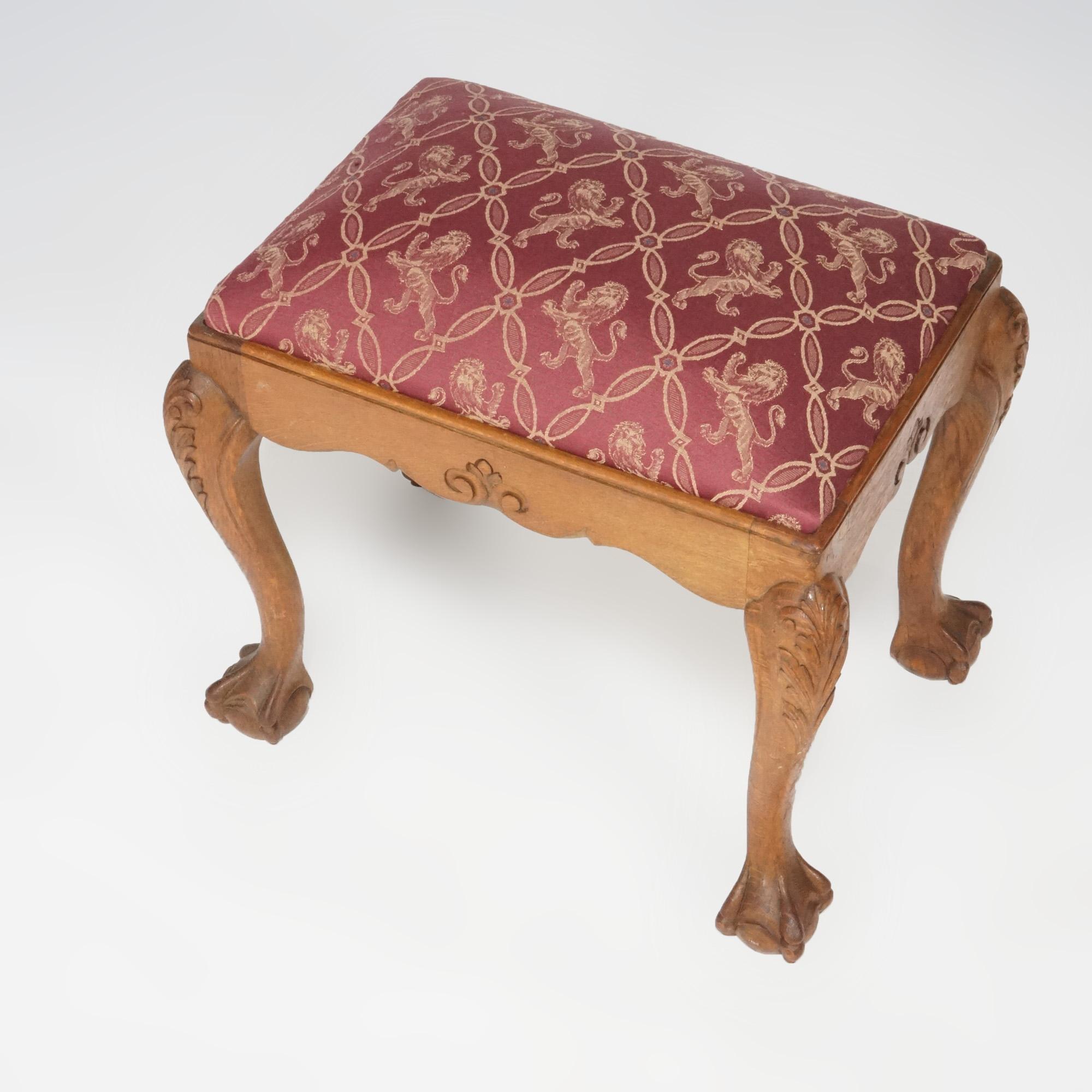 A Chippendale style bench offers upholstered seat over oak base with carved foliate elements, raised on cabriole legs having acanthus knees and terminating in claw and ball feet, 20th century

Measures- 19.5''H x 21.25''W x 15.25''D.