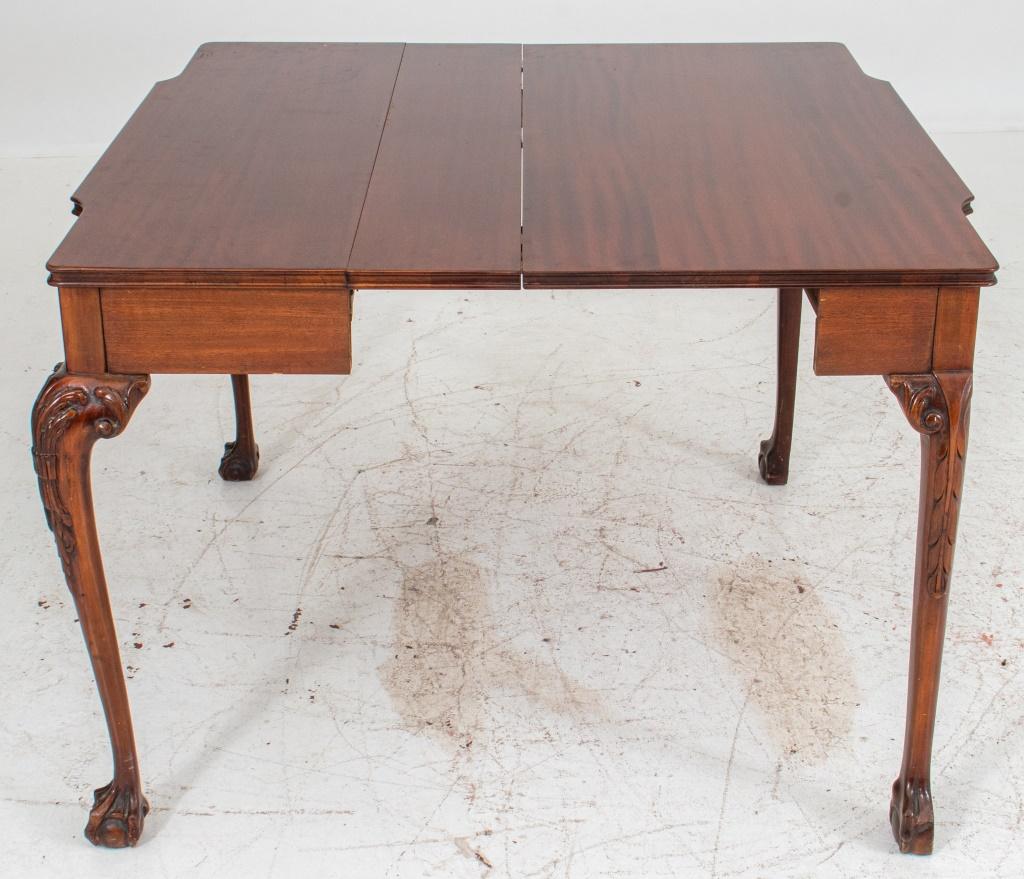 Chippendale style extending pier table (with three leaves) the shaped rectangular top above a carved center panel, supported by acanthus carved cabriole legs on claw-and-ball feet. 

Dealer: S138XX
