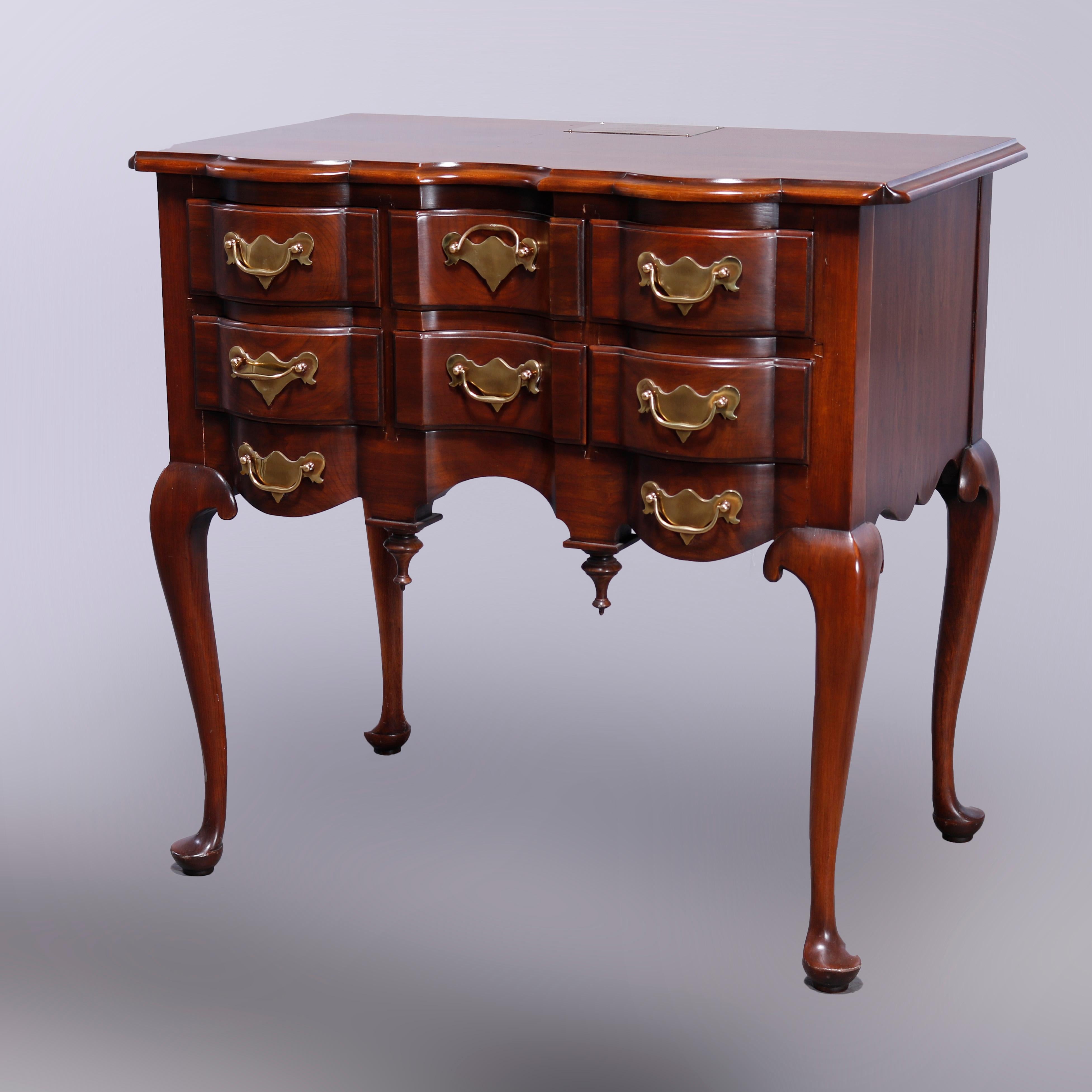 A Chippendale style low boy dressing table by Harden offers cherry construction with shaped top over shaped case with drawers and drop finials, raised on cabriole legs terminating in pad feet, 20th century

Measures - 31.75