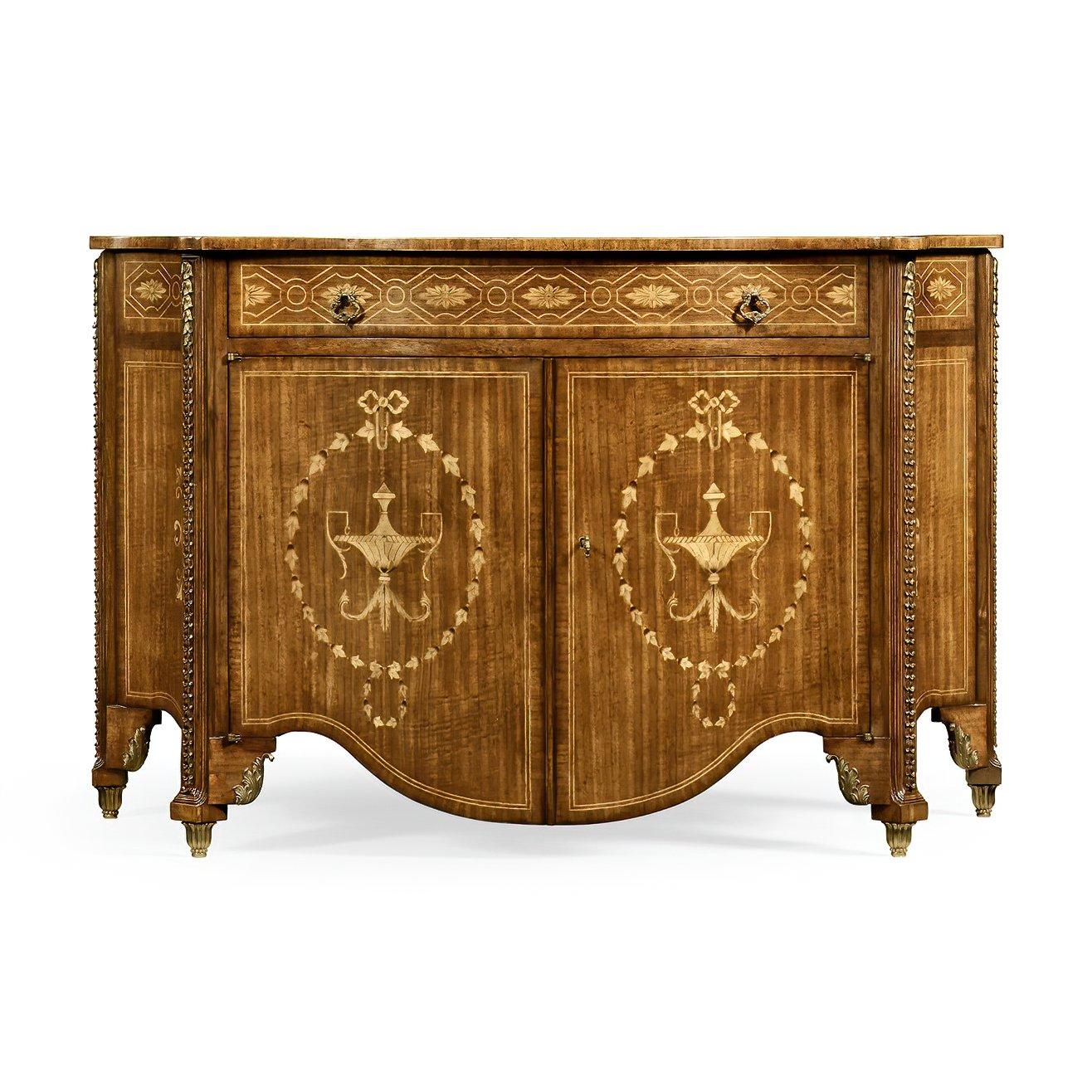 Spectacular crossbanded and marquetry inlaid chest of drawers with fine carved detail and cast brass mounts after a Thomas Chippendale original, the detailed serpentine doors opening to reveal three further graduated drawers within. After an