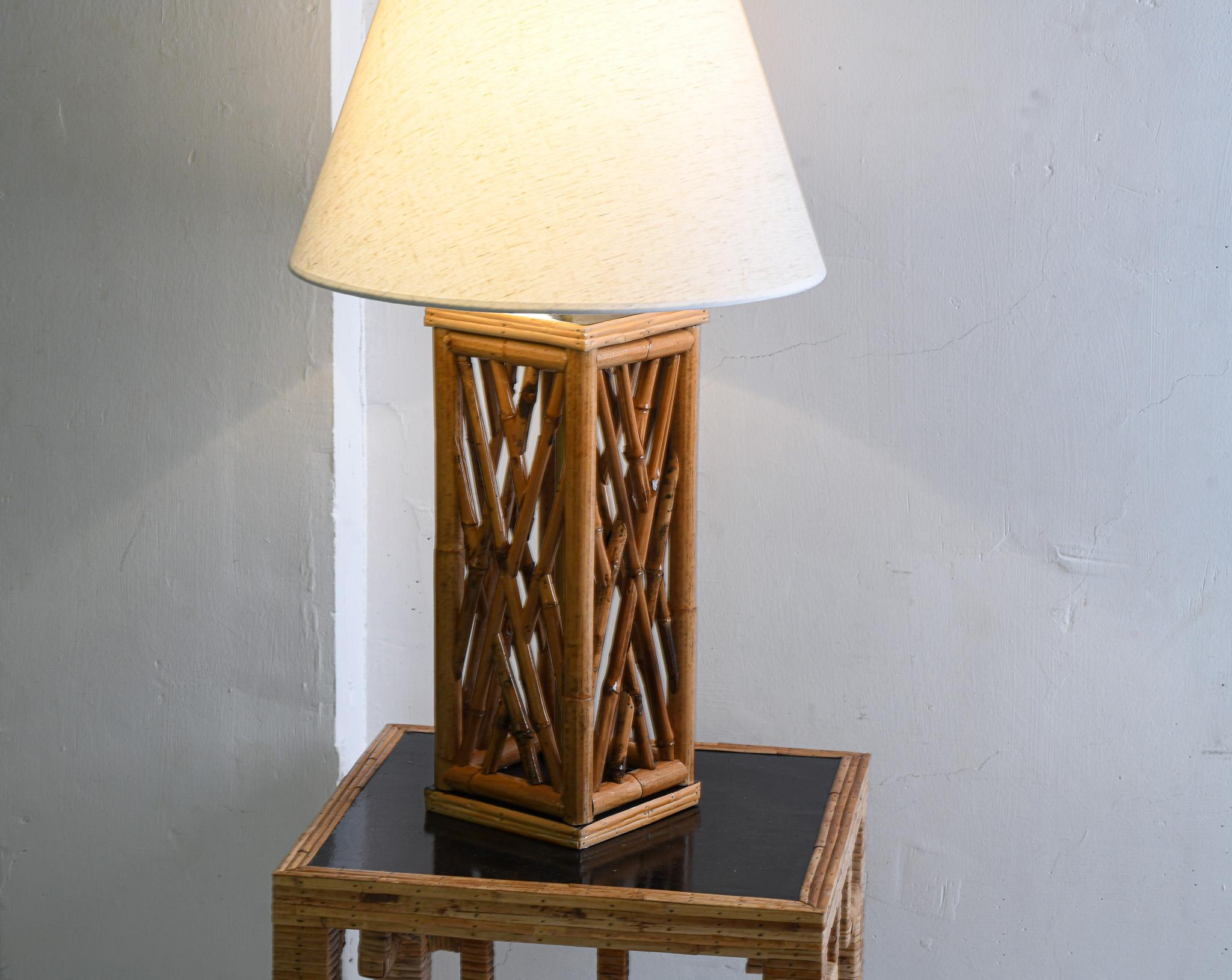 Transform your space into a sophisticated haven with our Chippendale Brighton pavilion styled Bamboo & rattan Table Lamp. Crafted with intricate lattice bamboo, each lamp boasts a patinated satin black lacquer base and gold accents, adding a touch