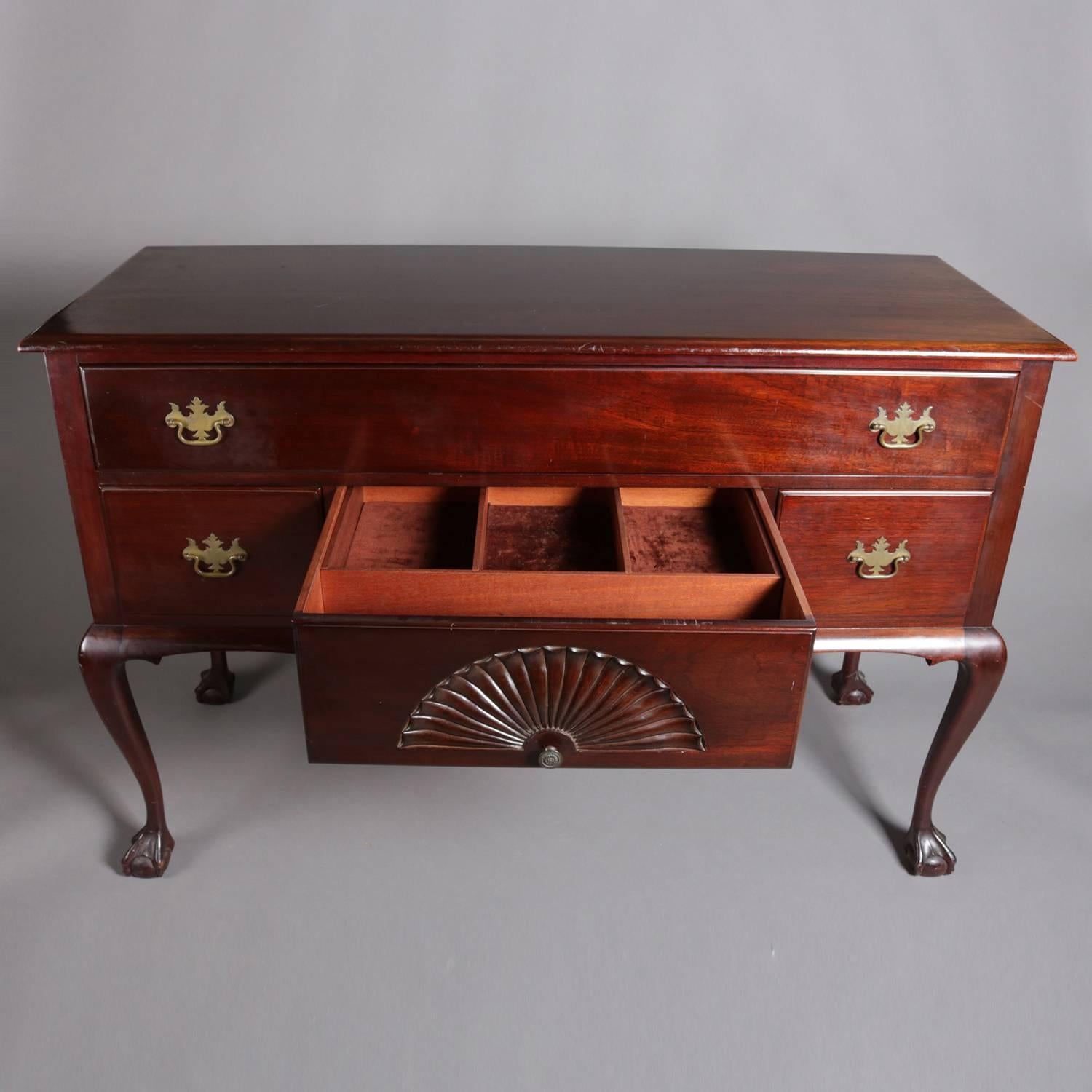 Chippendale style server feature mahogany construction with one long upper drawer above central silver and flanking drawers, silver drawer with carved scallop shell, raised on cabriole legs terminating in claw and ball feet, brass pulls throughout,