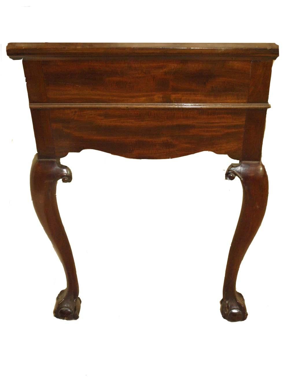 Chippendale style mahogany console with beautifully faded mahogany top, the top two drawers have reeded fronts and original open fretwork brass pulls separated by oval applied carved medallion, below are two additional drawers ( pull out from