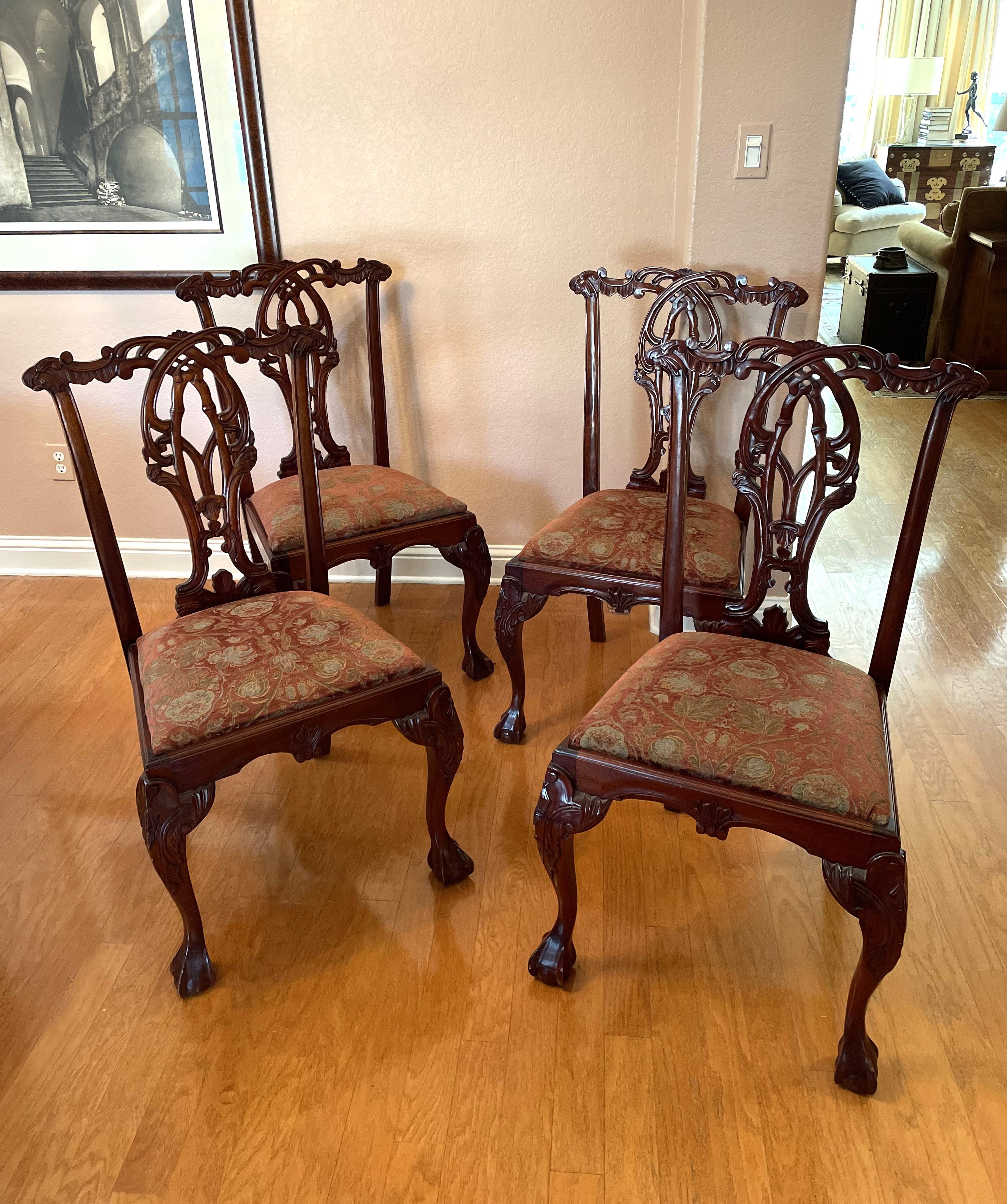 A strikingly graceful set of 4 solid mahogany Chippendale-style dining chairs in excellent condition, with minor imperfections characteristic of age. Also included in the shipment will be two additional upholstered seats, useful given that the