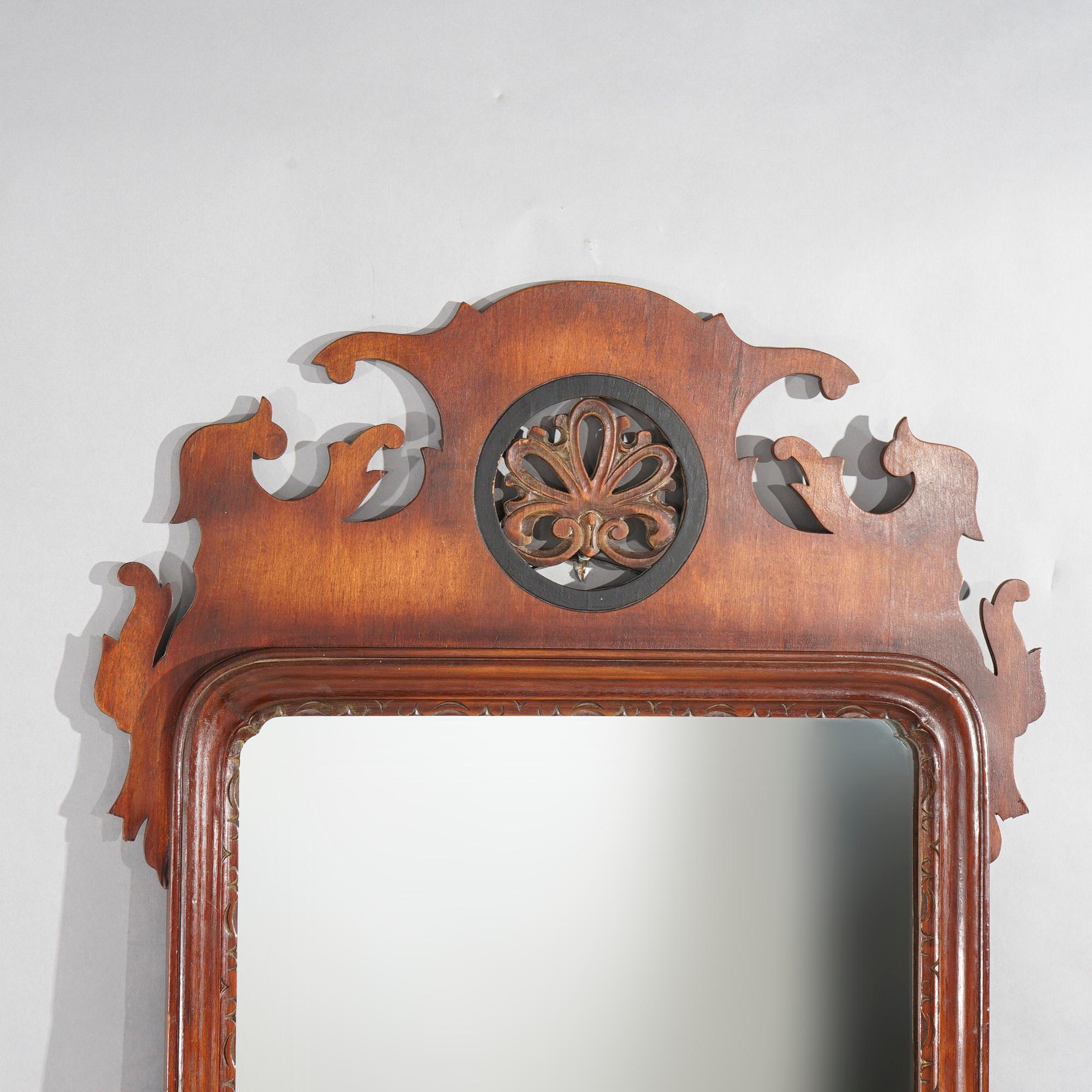 A Chippendale style wall mirror by Simonds offers mahogany frame with stylized cutout flower in ebonized surround at crest over, en verso maker label as photographed, c1940

Measures- 44.25''H x 23.25''W x 1.5''D.

*Ask about DISCOUNTED DELIVERY