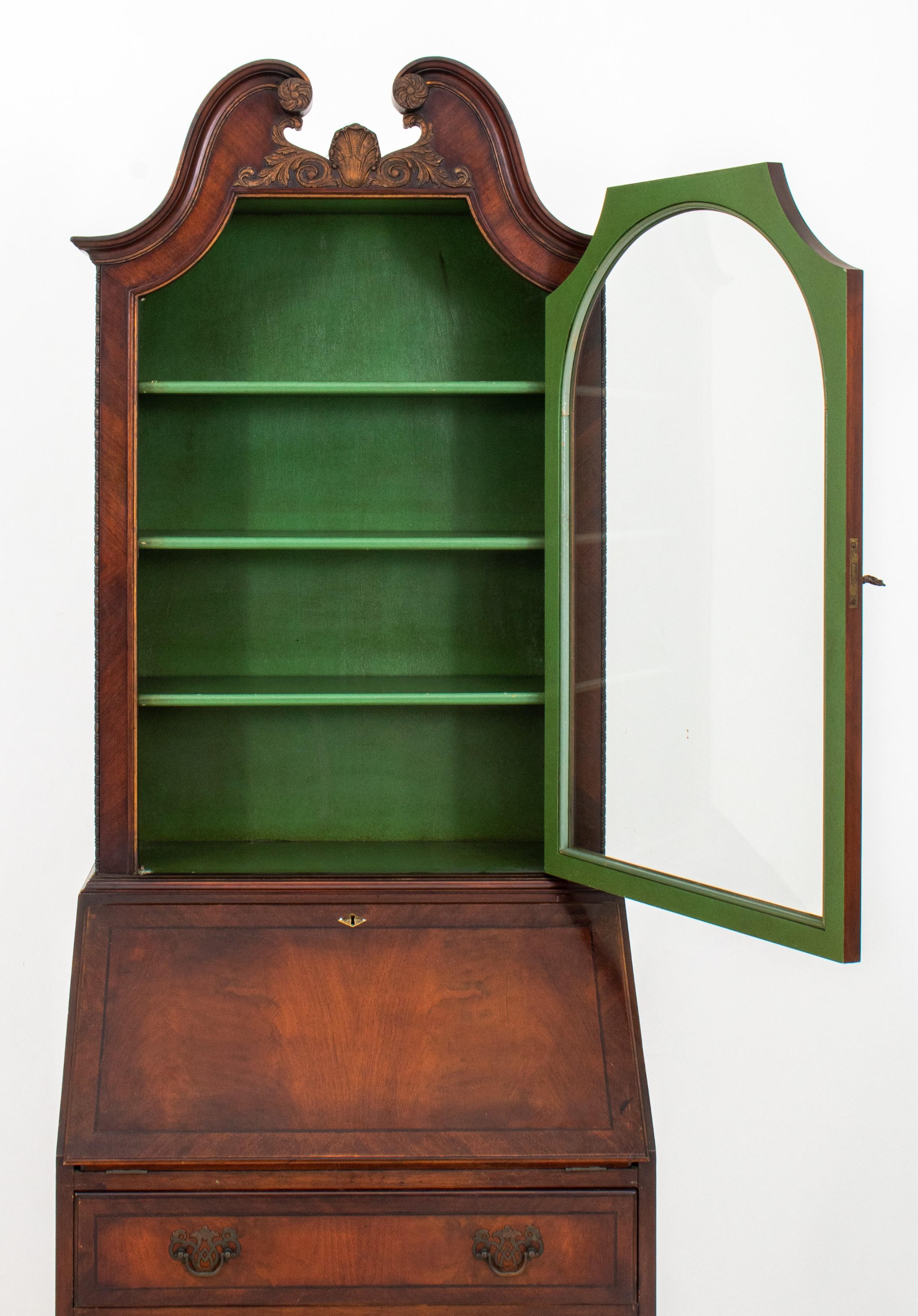 Chippendale style mahogany secretary bookcase. Here are the details:

Style: Chippendale
Material: Mahogany
Features:
Scrolling broken swan's neck pediment finial
Glass cabinet door with green lacquered interior and three shelves
Slant front