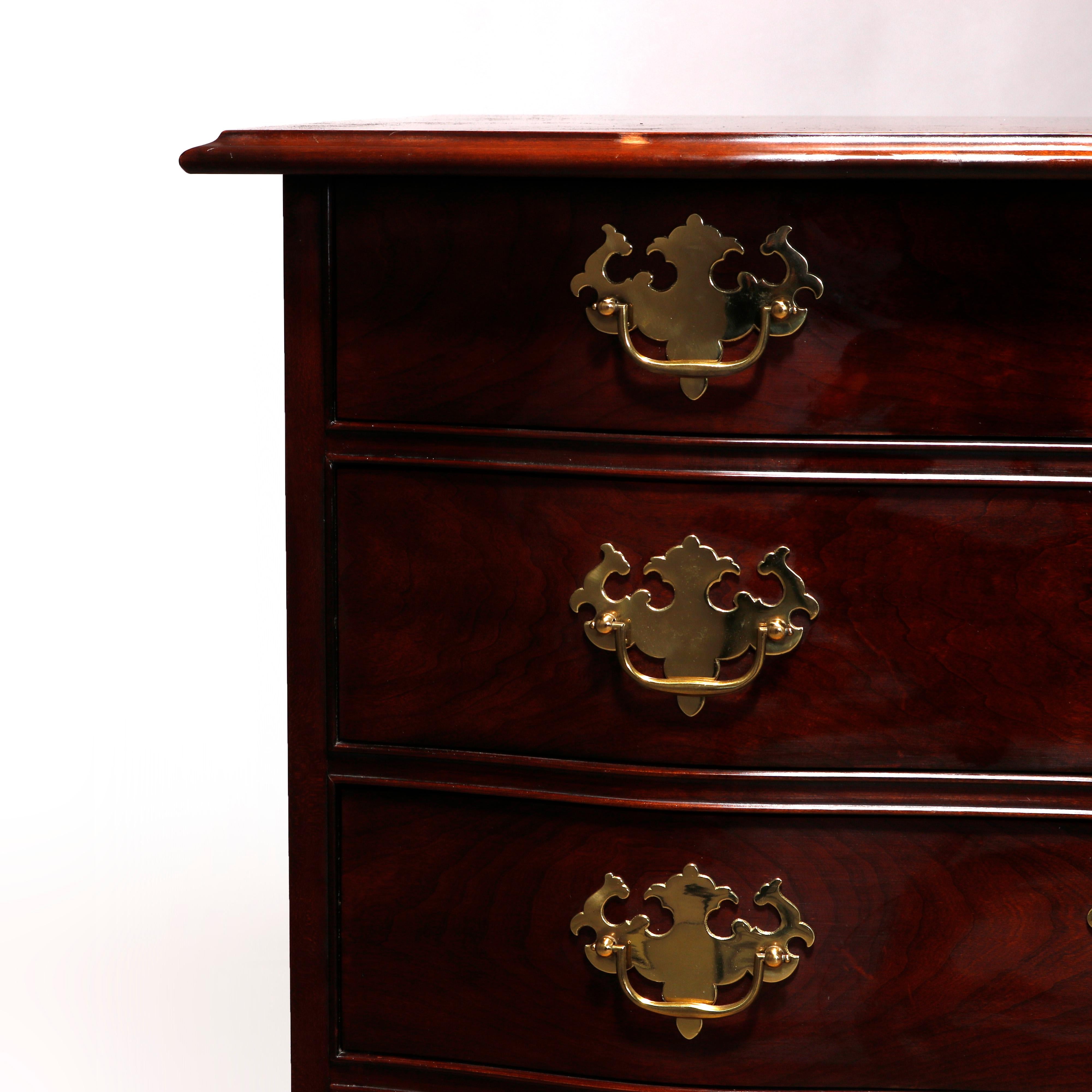 A vintage Chippendale style chest of drawers by Stratton Private Collection offers mahogany construction in serpentine form with shaped top surmounting case having four drawers and shaped skirt, raised on cabriole legs, cast brass pulls, maker label