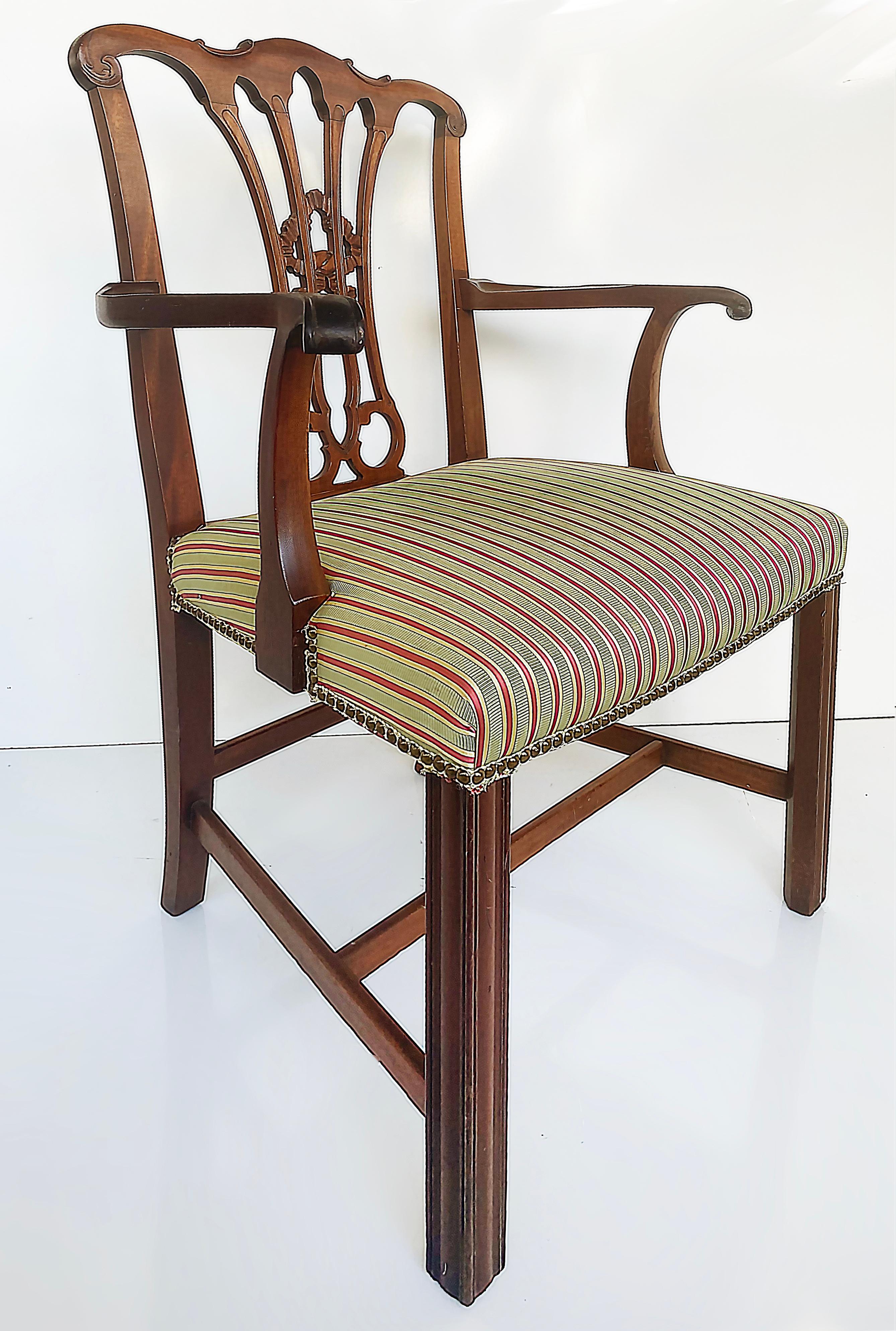 Chippendale style mahogany slat back armchair with upholstered seat cushion

Offered for sale is a Chippendale style mahogany armchair with a slat back, upholstered seat cushion with striped fabric, and brass metal nail head detailing. The legs