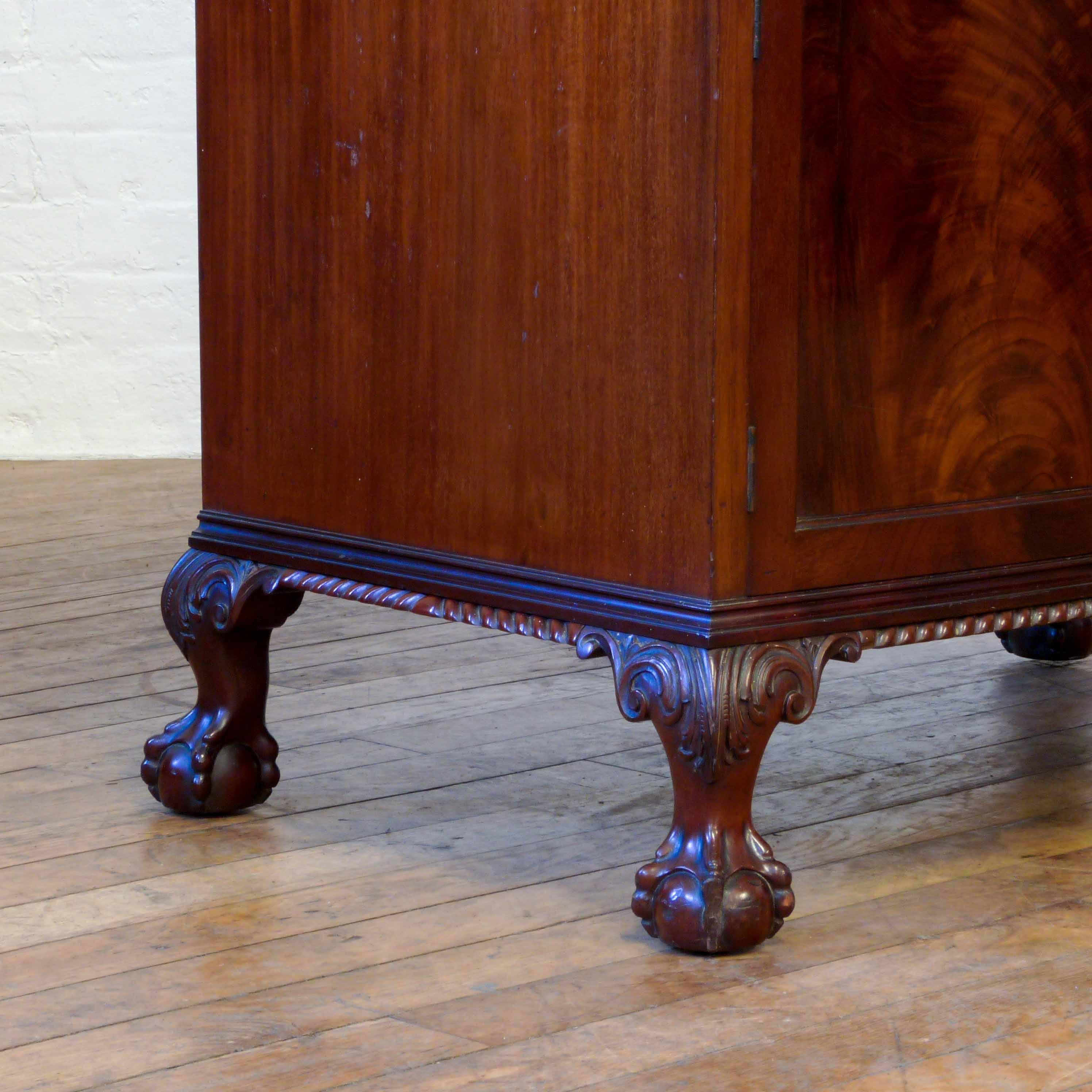A top quality mahogany tallboy in the Chippendale manner. The three top drawers and base doors have beautifully figured mahogany veneers, whilst the base has bold ball and claw feet with crisp acanthus carving to the shoulder and an attractive